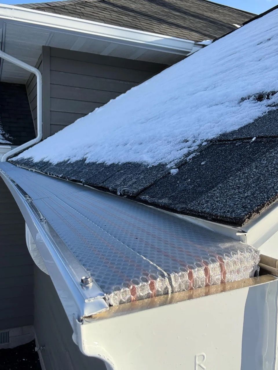 Different angle of gutter with screens and plastic on top.