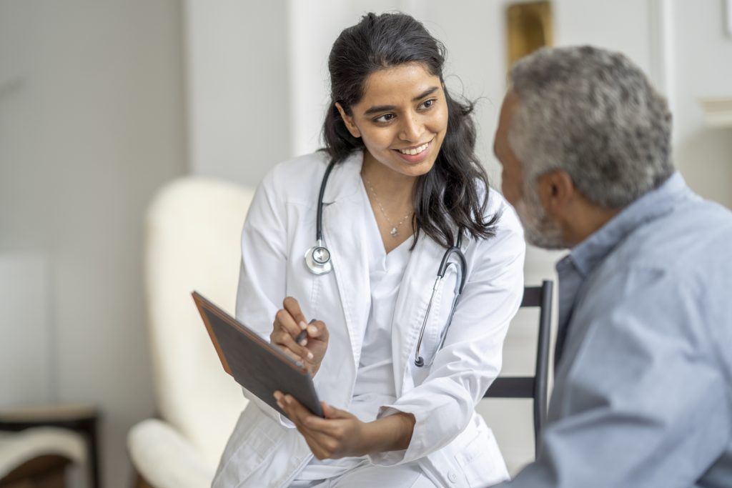doctor with patient - medicare may cover cosmetic procedure
