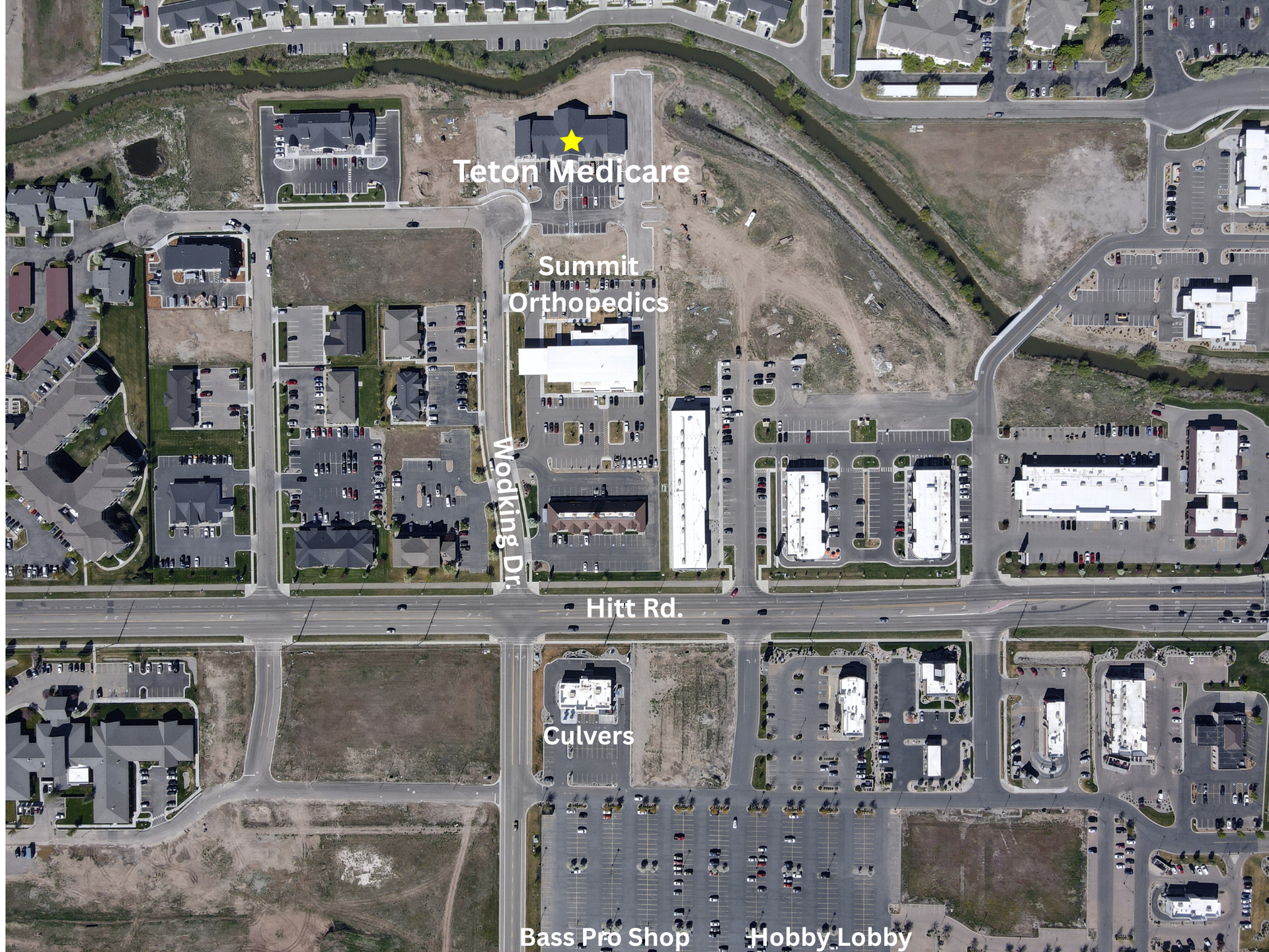 Aerial view of a commercial area with labeled buildings including 