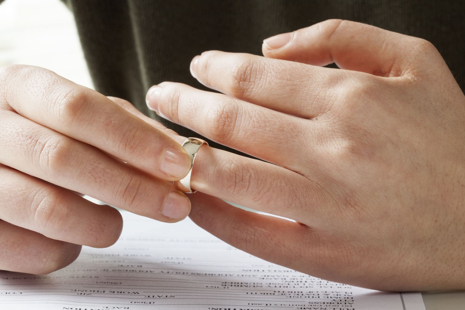 A woman is putting a wedding ring on a man 's finger