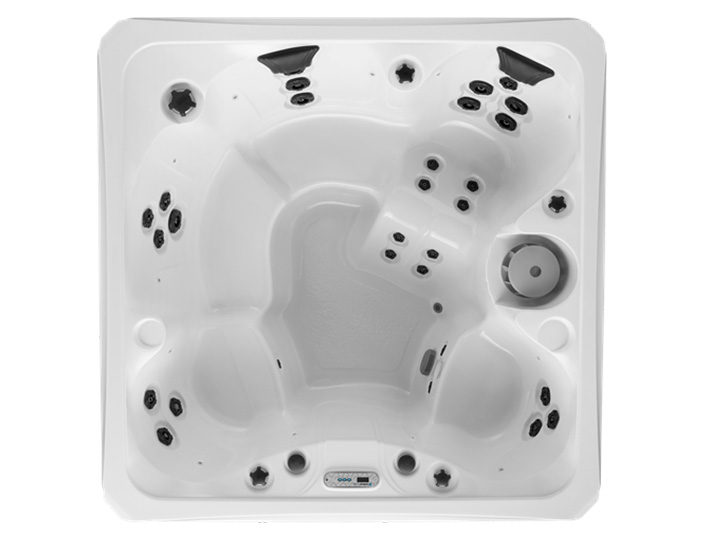 White hot tub with multiple black jets and built-in seats, viewed from above.