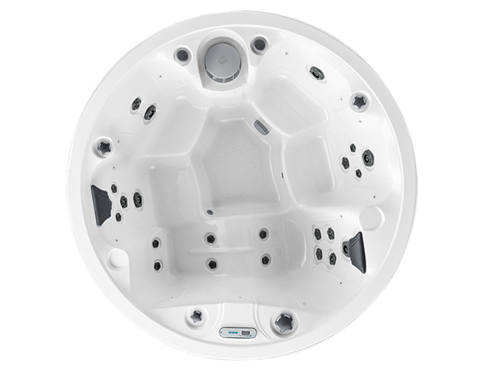 White circular hot tub/spa with multiple jet nozzles and headrests, viewed from above