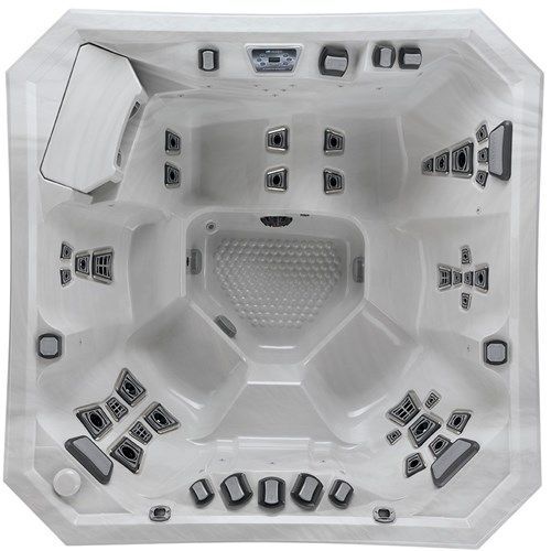 White octagonal hot tub interior with multiple black jets and built-in seats, viewed from above