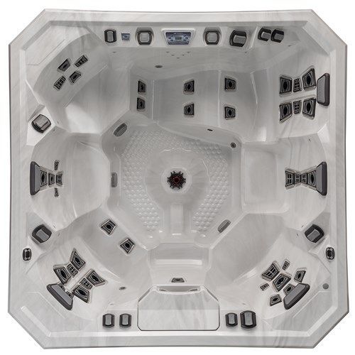 Top-down view of a white geometric hot tub with multiple built-in jets and seats