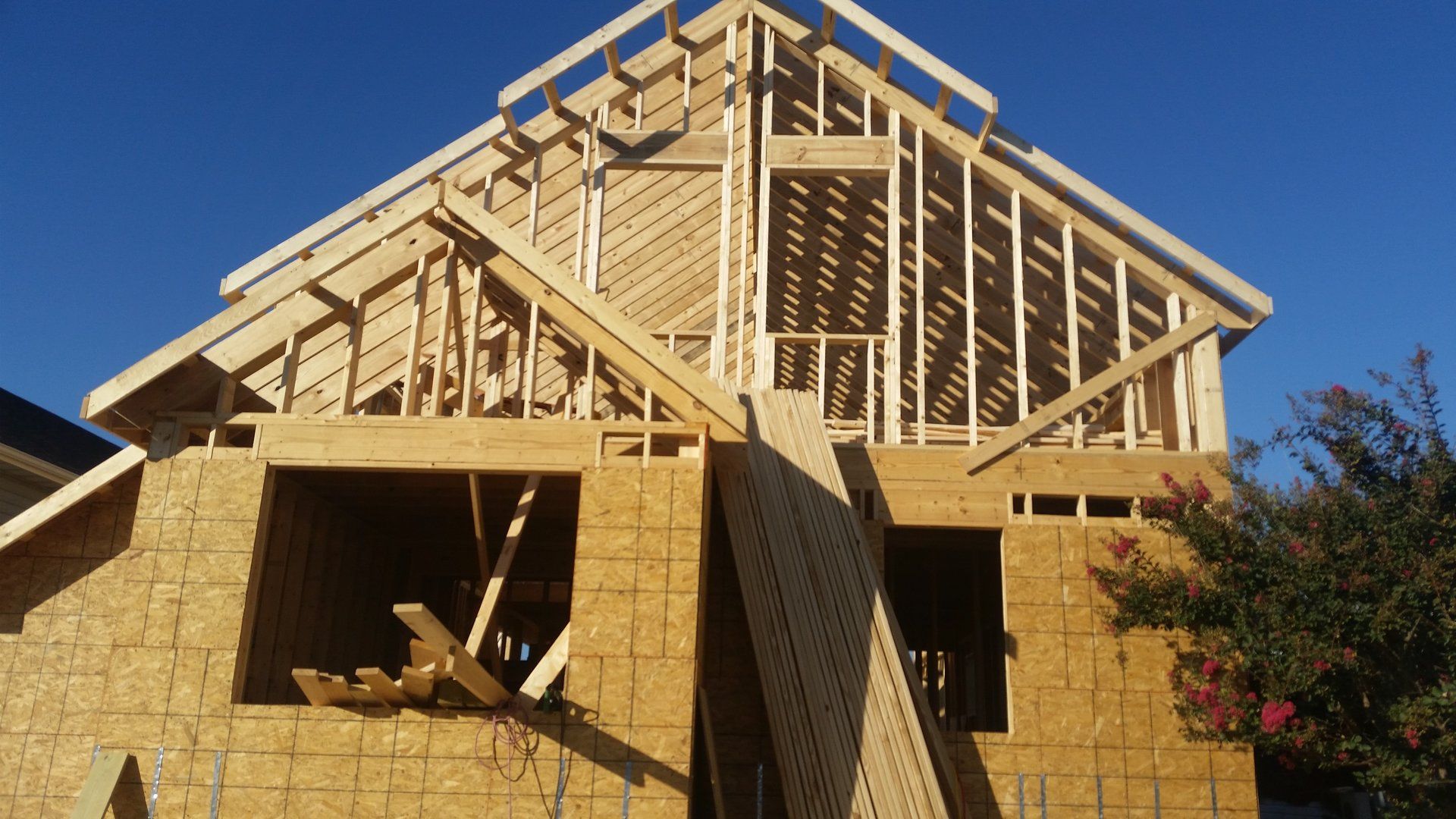 A house that is being built with a blue sky in the background