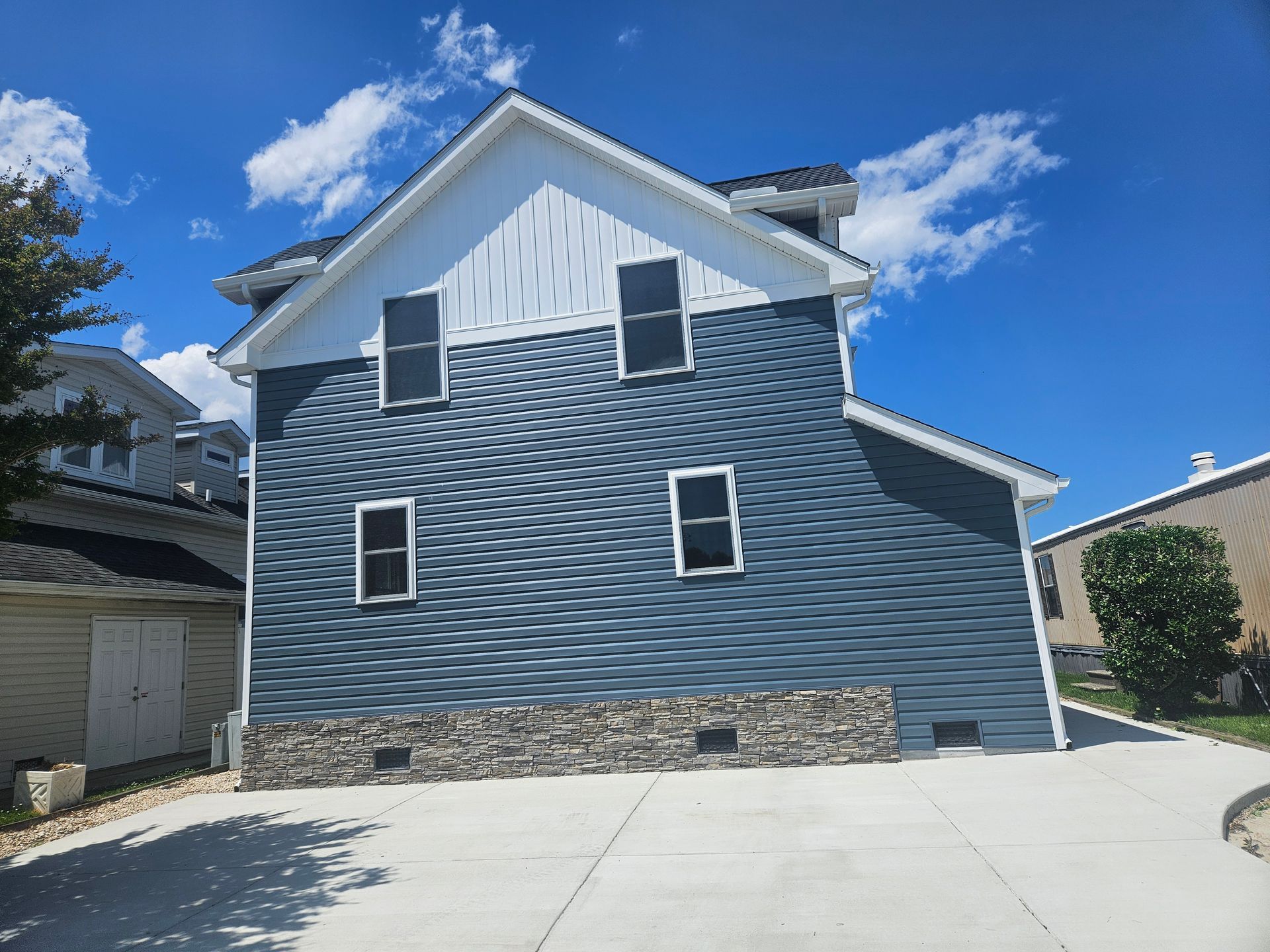 A large house with a lot of windows and a driveway