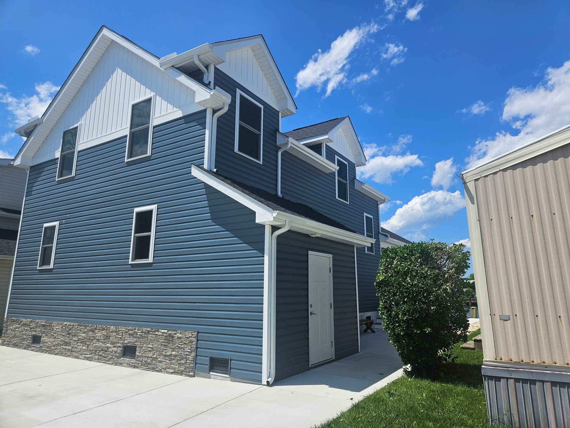 A house with a blue siding and white trim