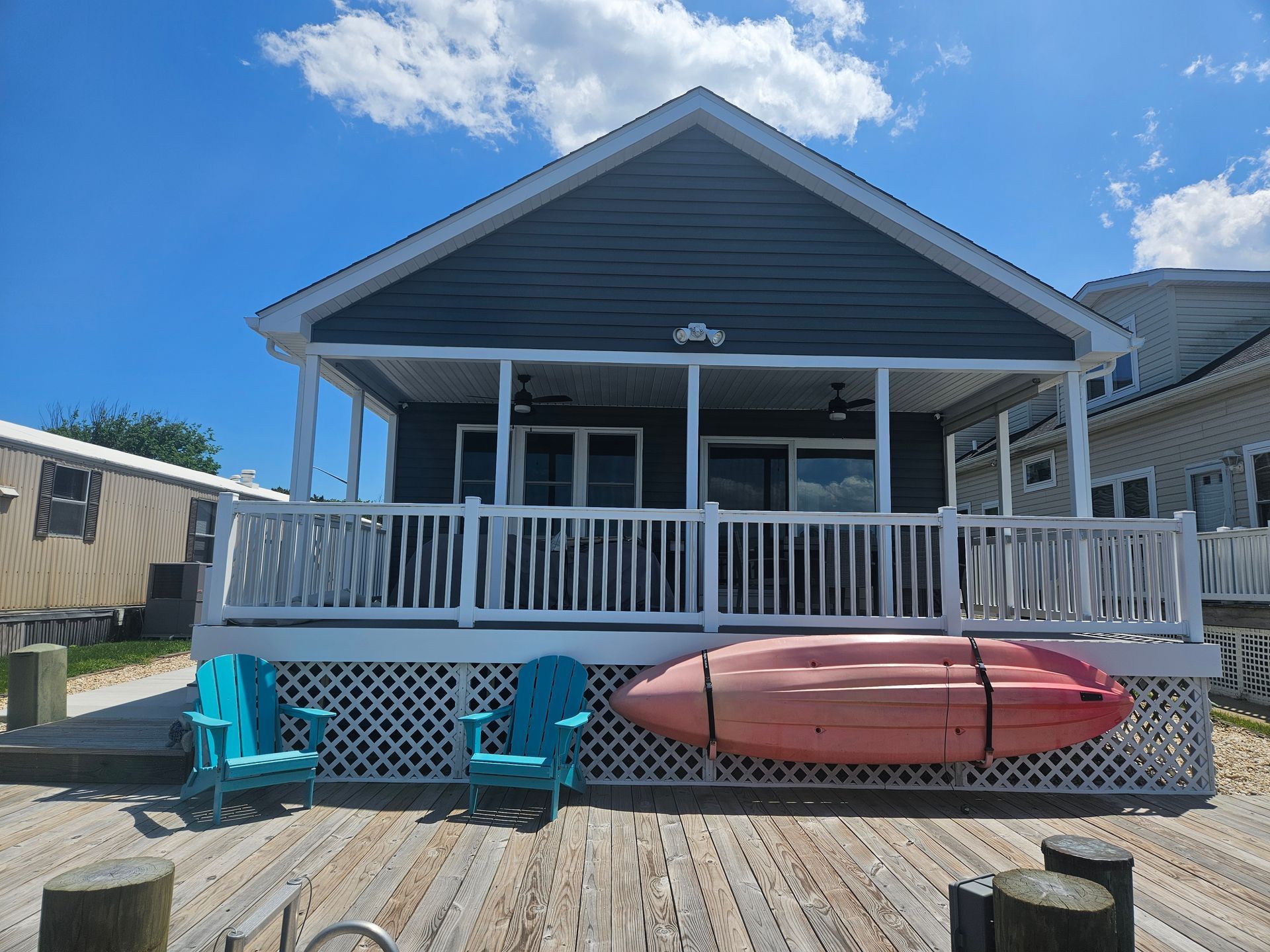 A house with a porch and a kayak on the deck