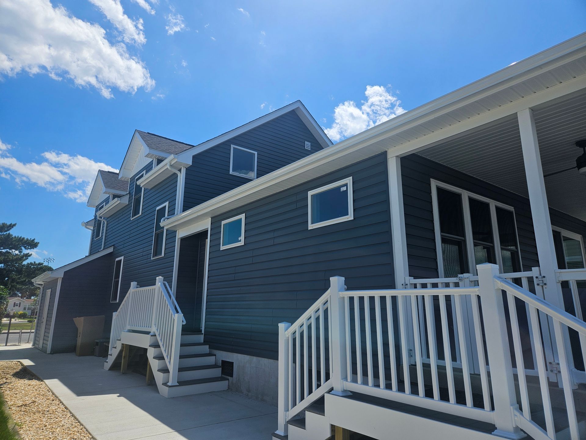 A blue house with a white porch and stairs