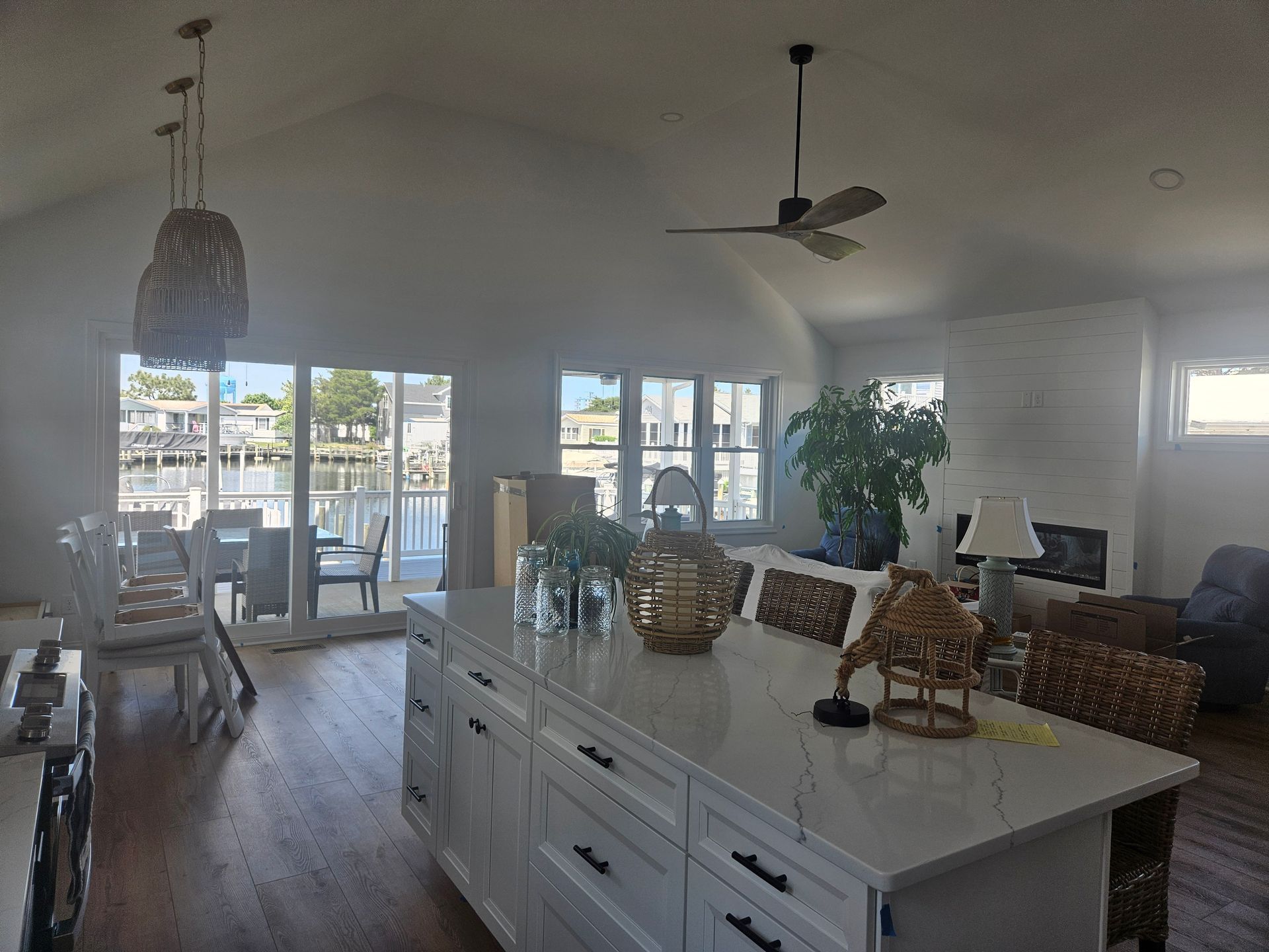 A living room with a large island in the middle and a ceiling fan