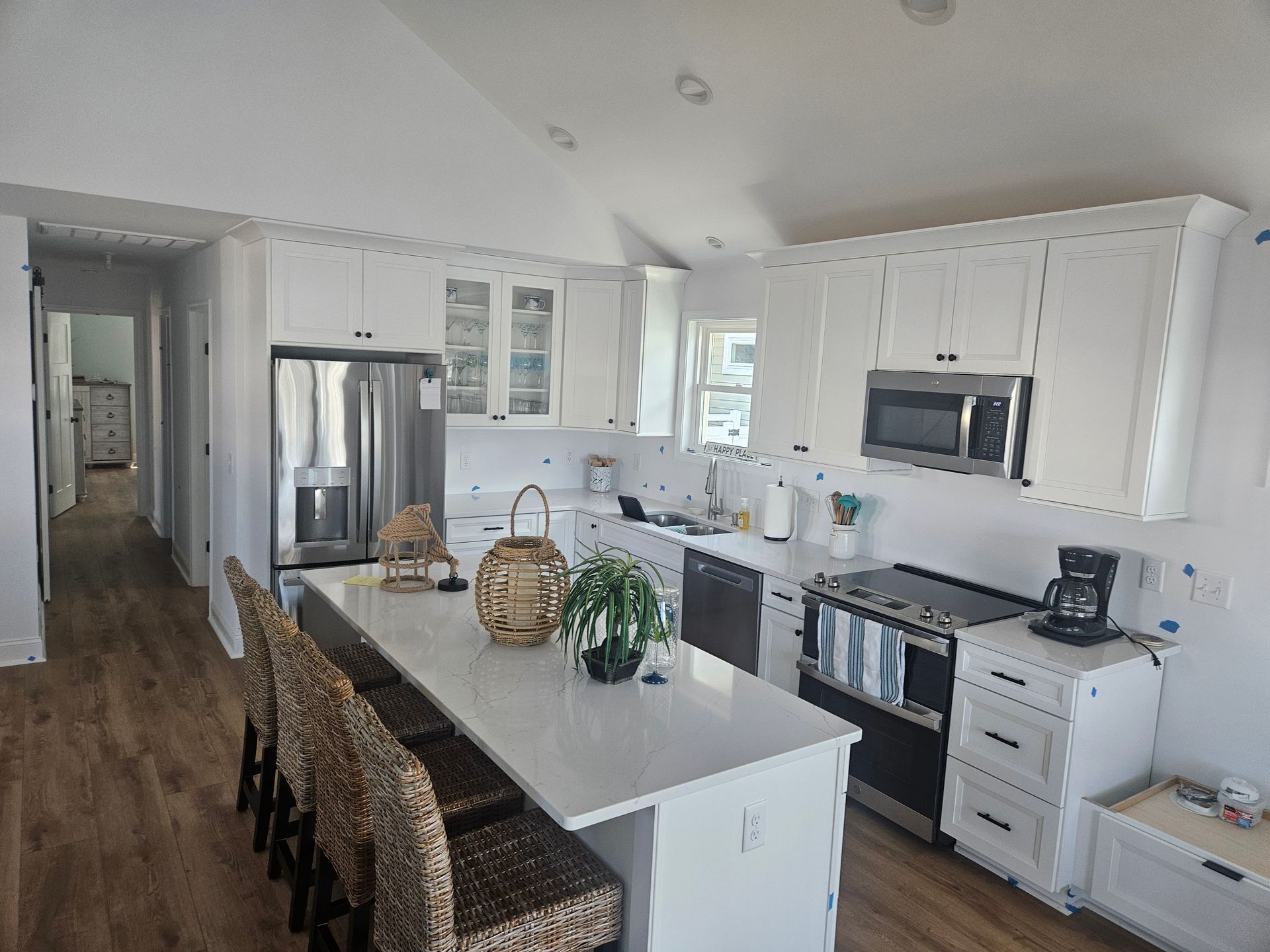 A kitchen with white cabinets and stainless steel appliances