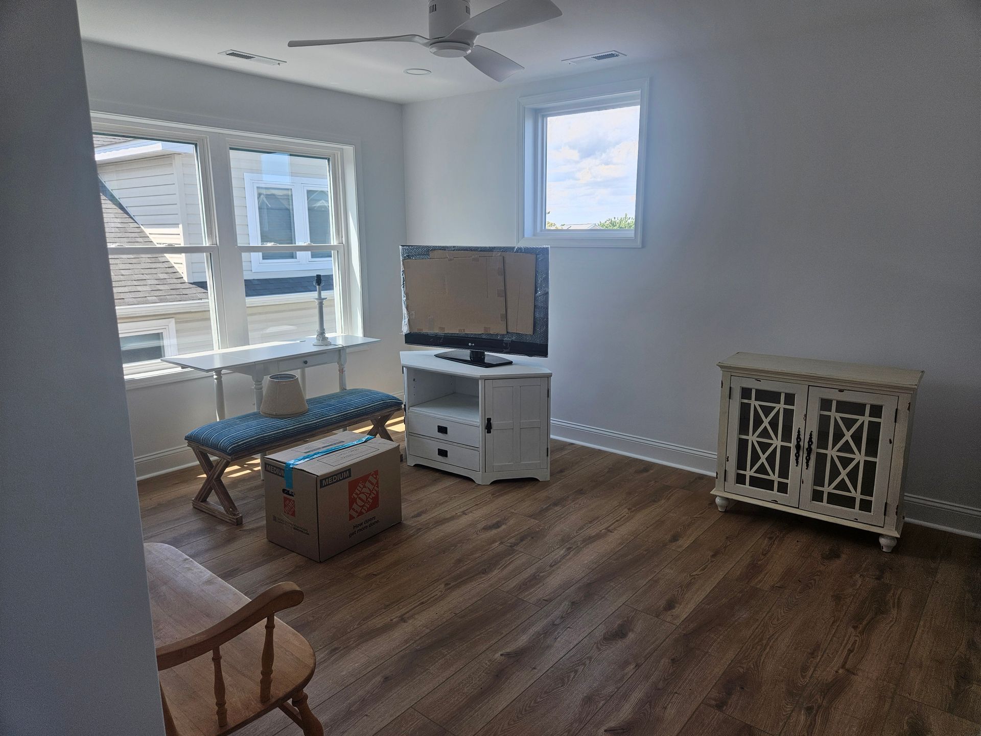 A living room with hardwood floors and a flat screen tv