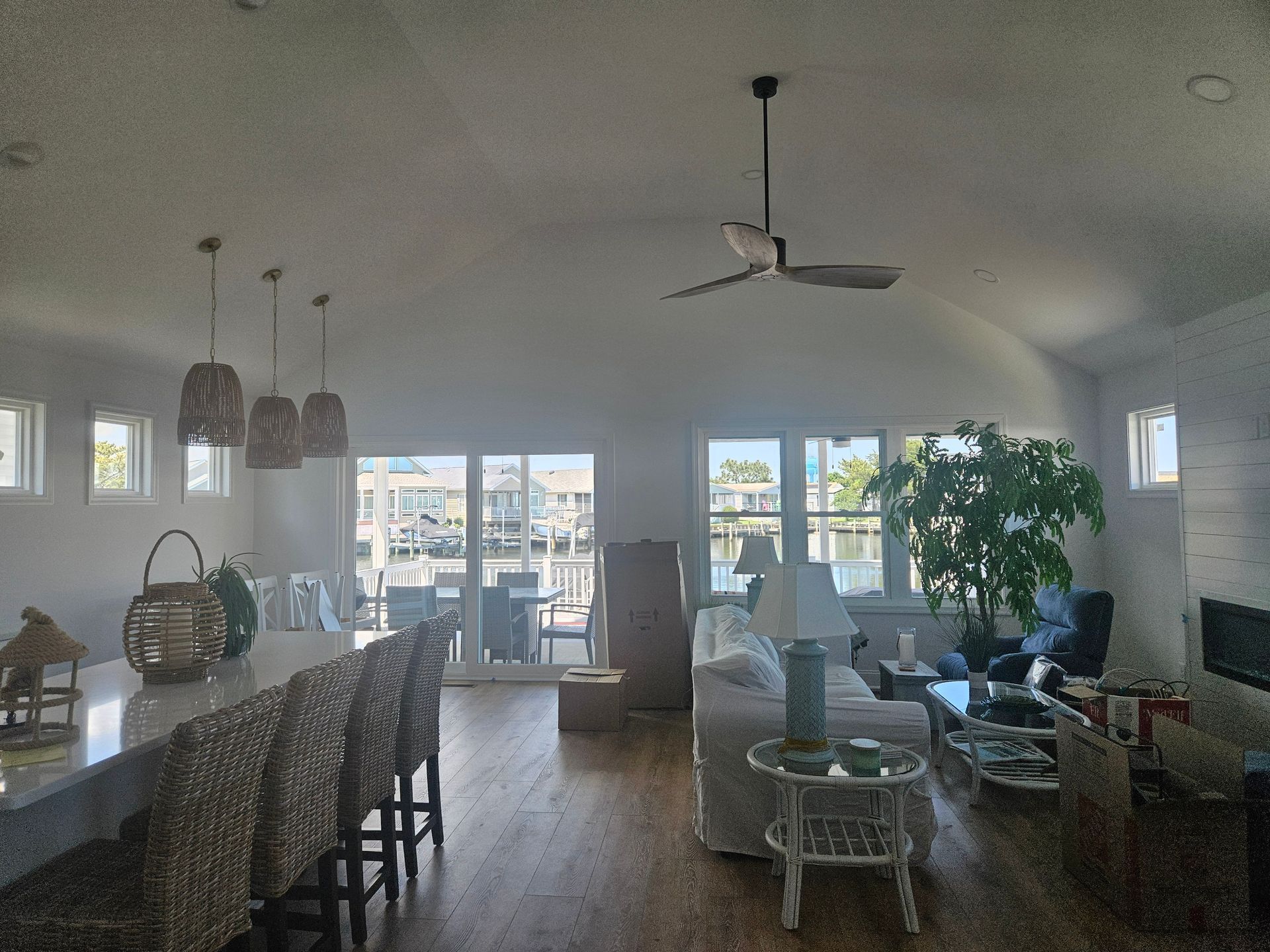 A living room with a lot of furniture and a ceiling fan