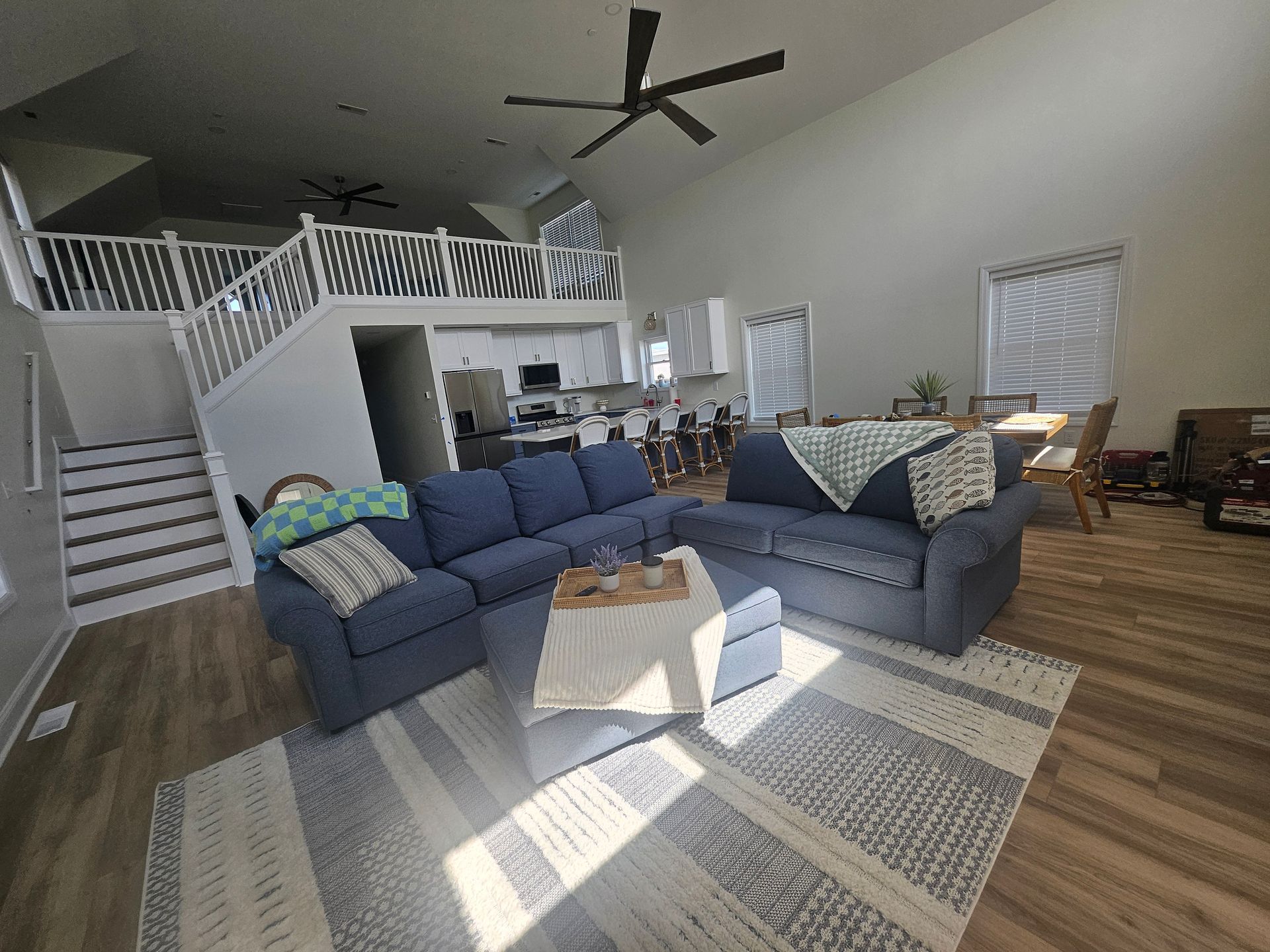 A living room with a blue couch and a white coffee table