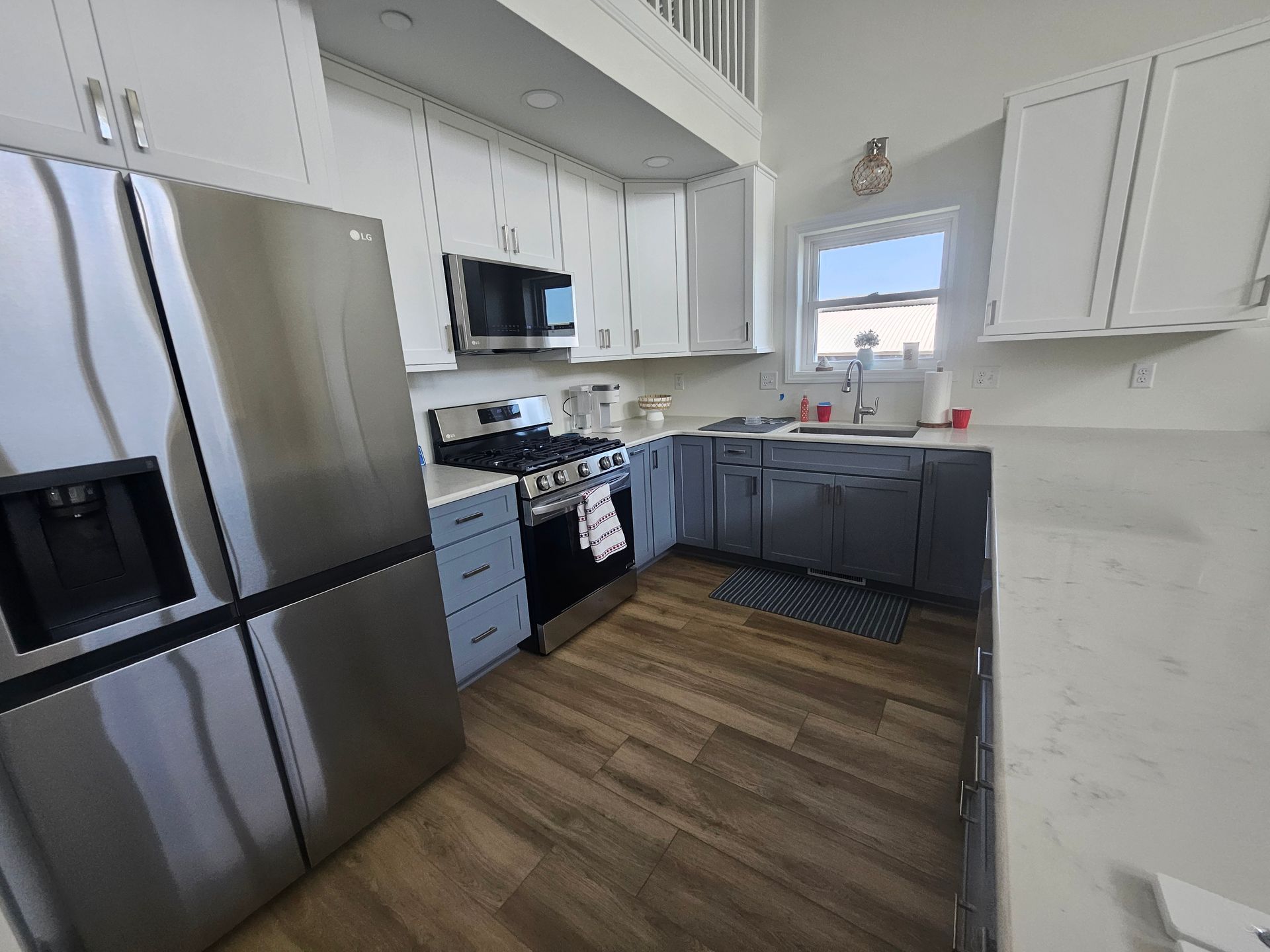 A kitchen with stainless steel appliances and white cabinets