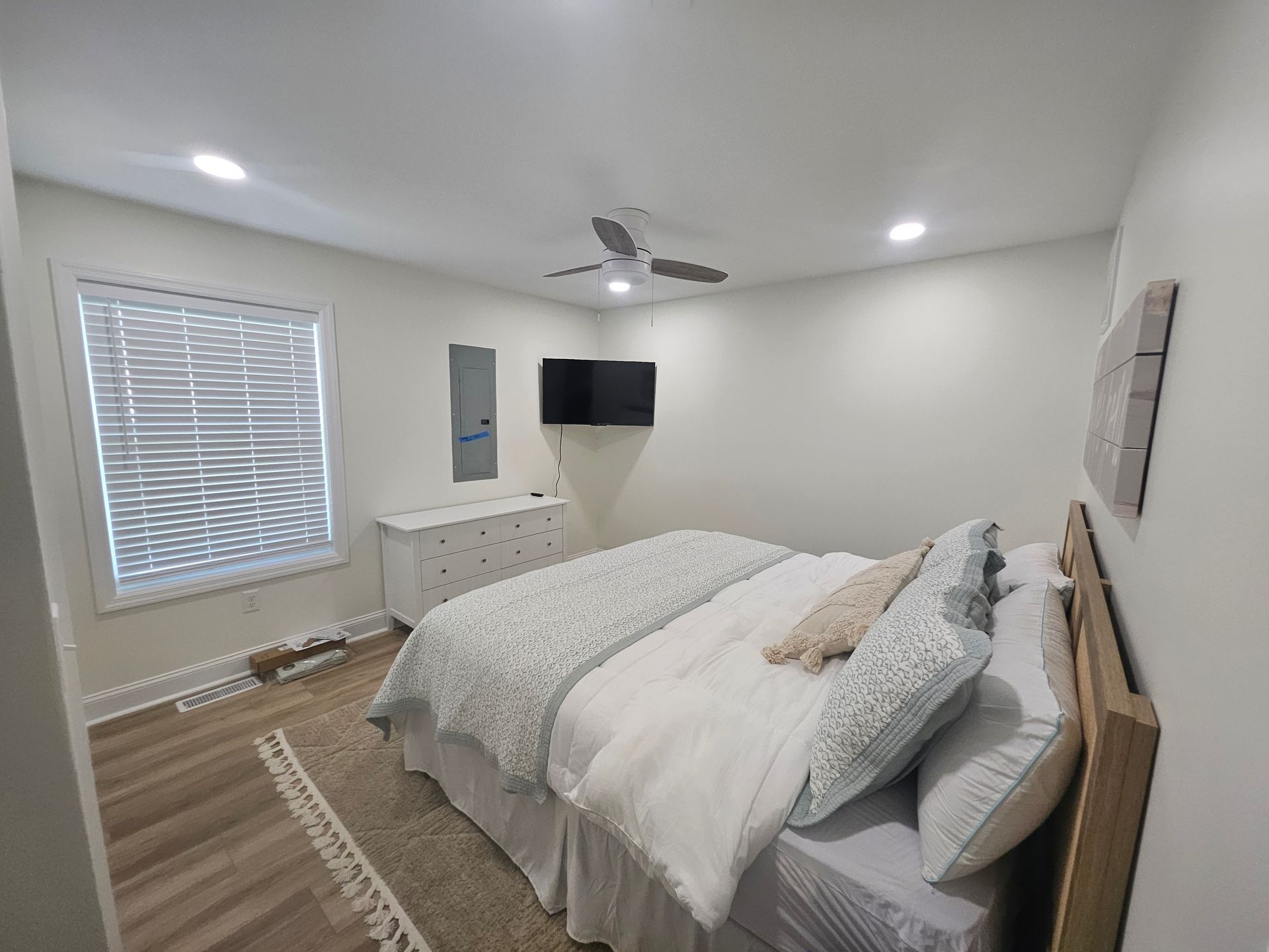 A bedroom with a king size bed and a flat screen tv