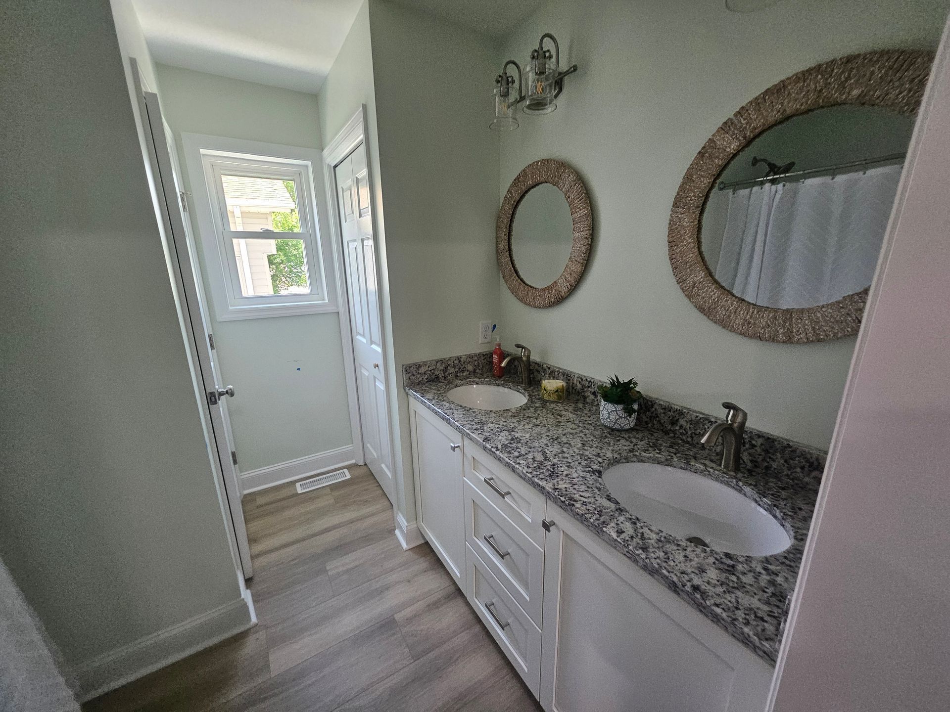 A bathroom with two sinks and two mirrors