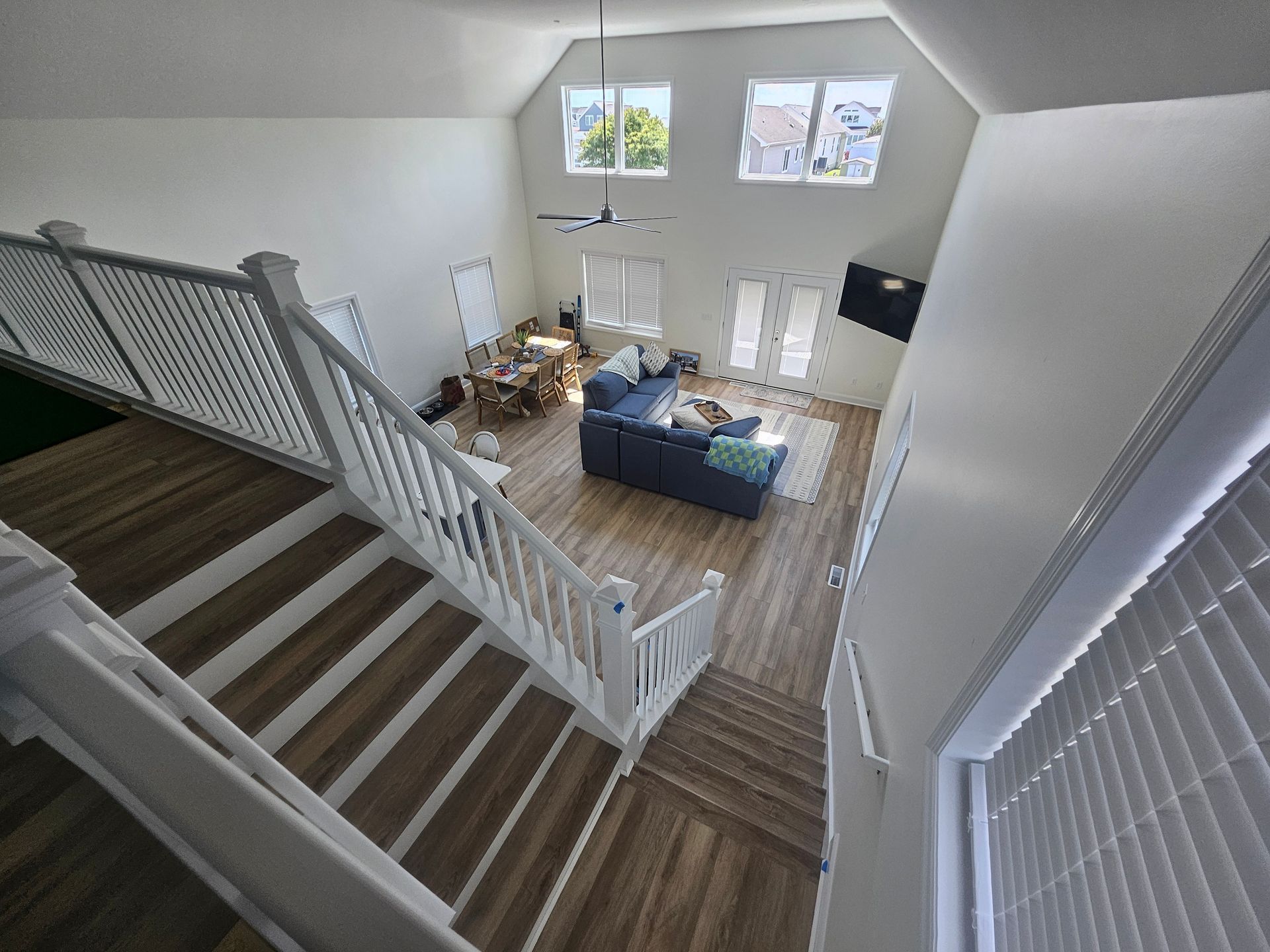 An aerial view of a living room with stairs leading up to it