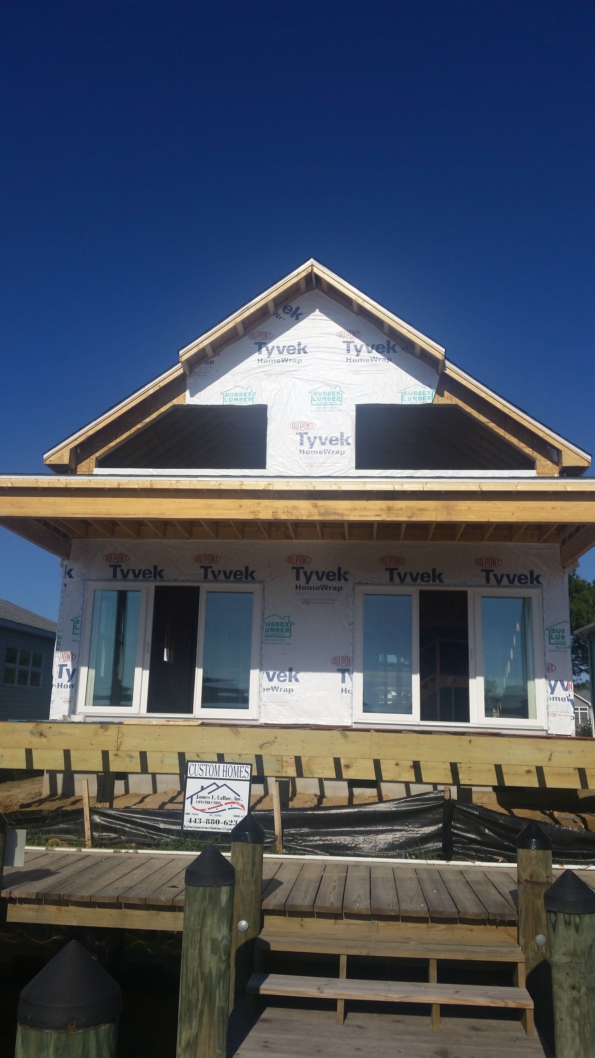 A house is being built on a dock next to a body of water