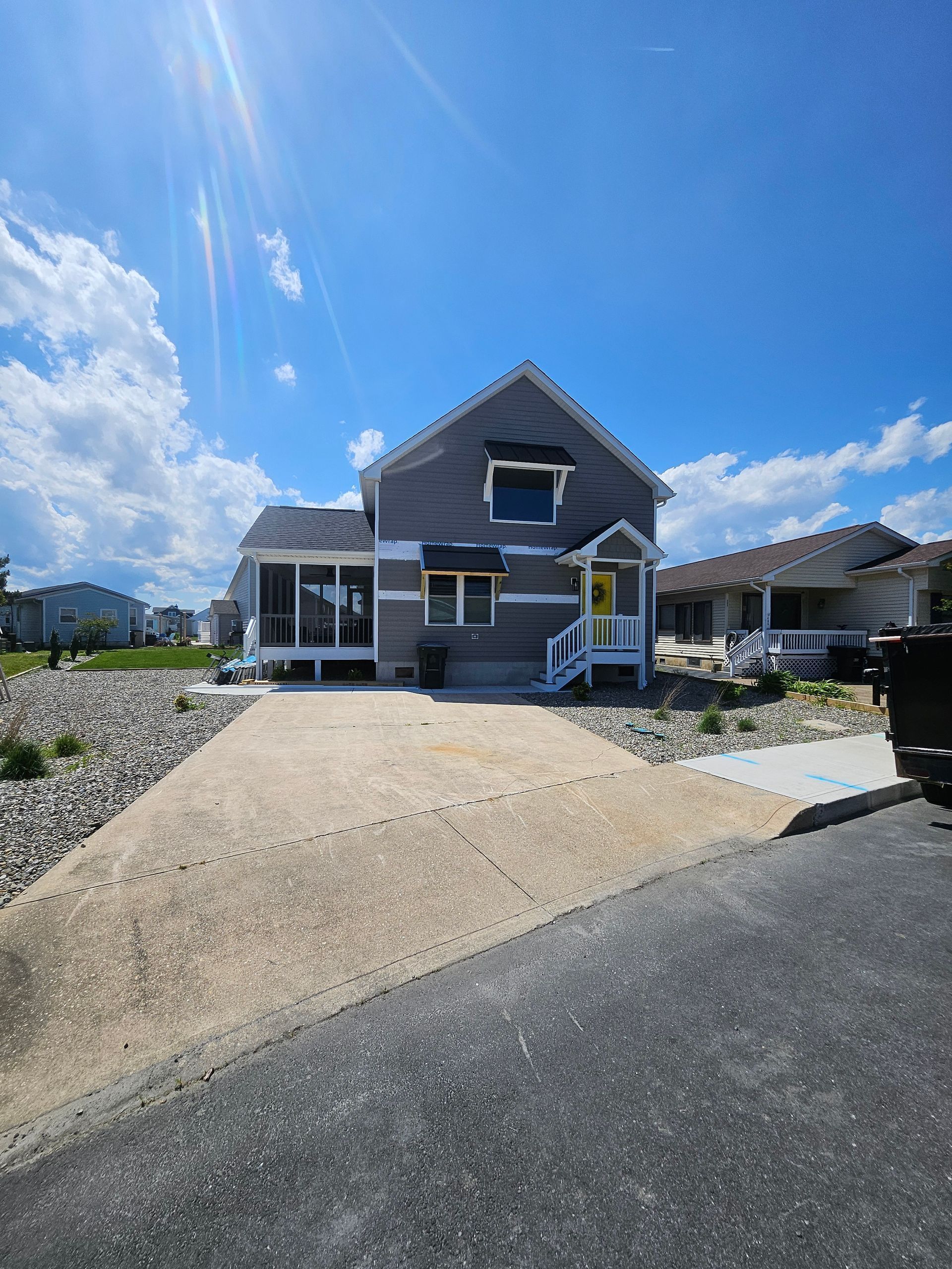 A large house with a driveway leading to it is sitting on top of a hill