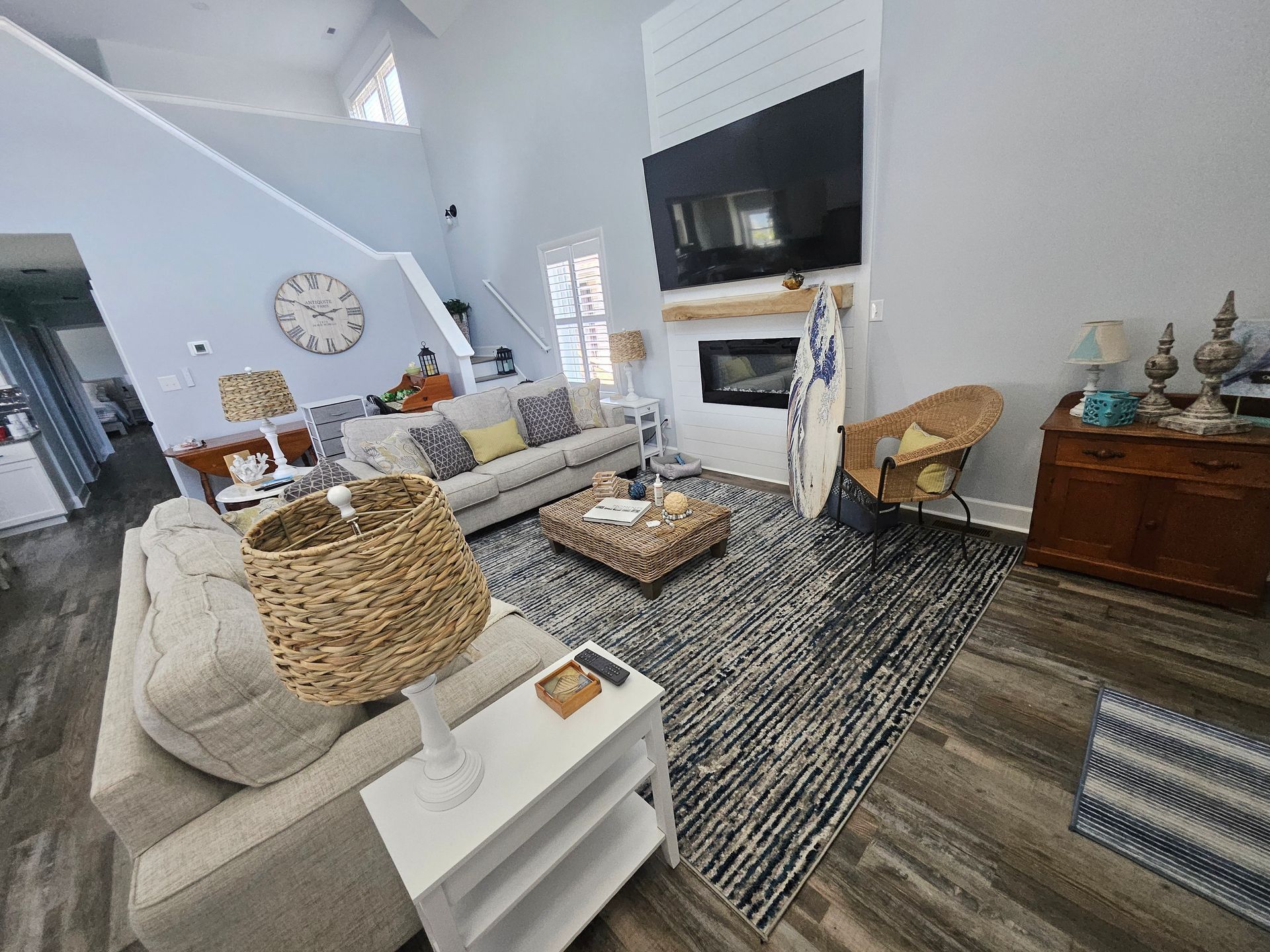 A living room with a couch, chair, coffee table and television