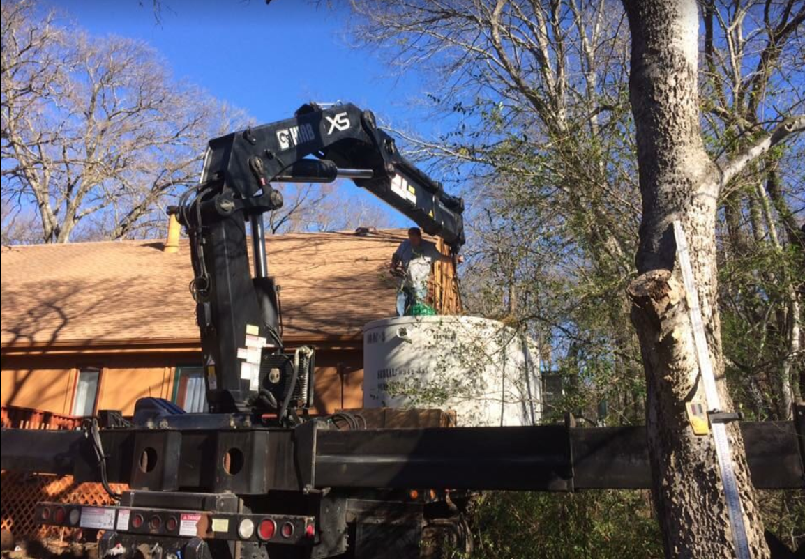 Heavy machine carrying a septic tank