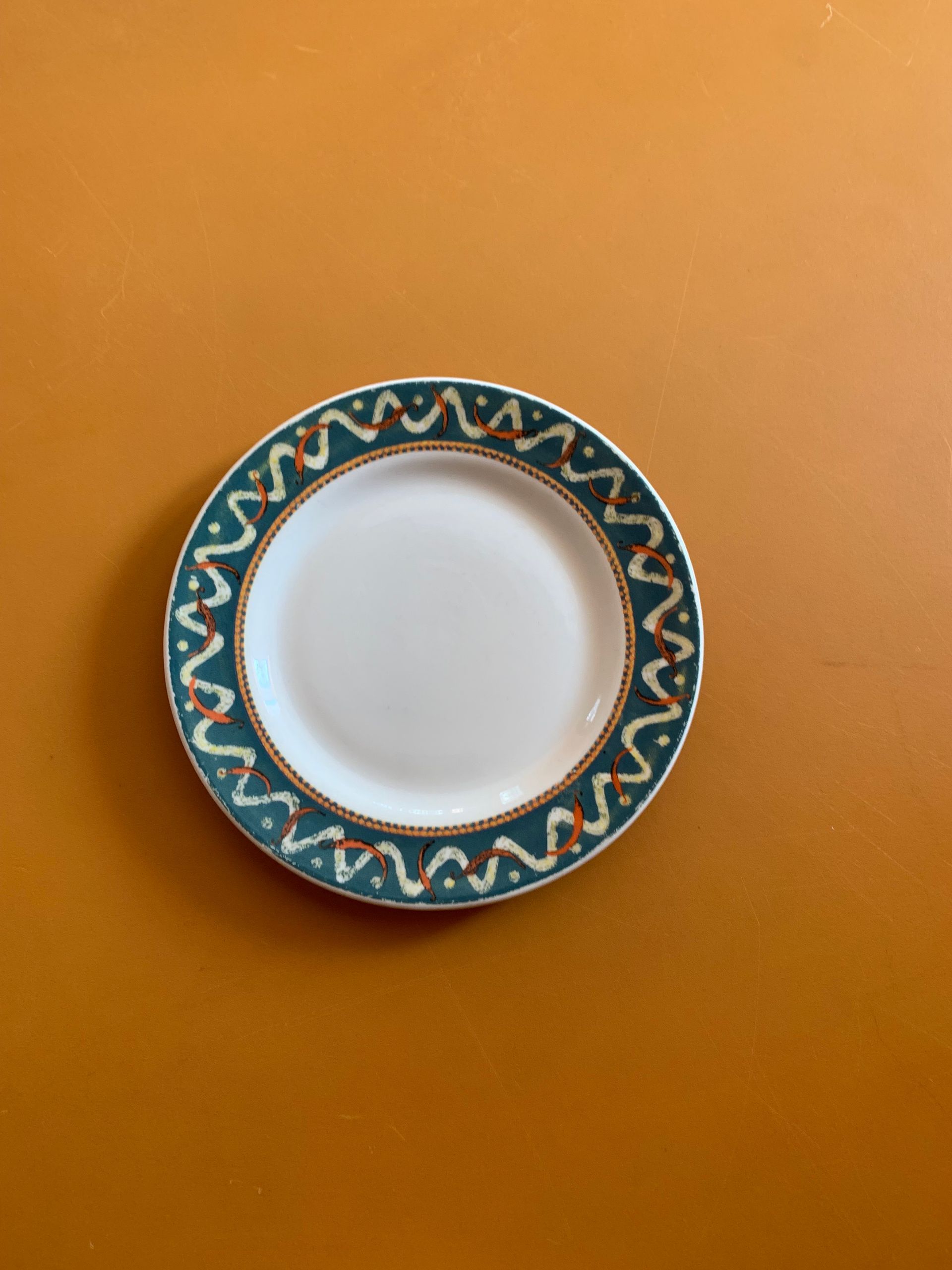 A white plate with a green border