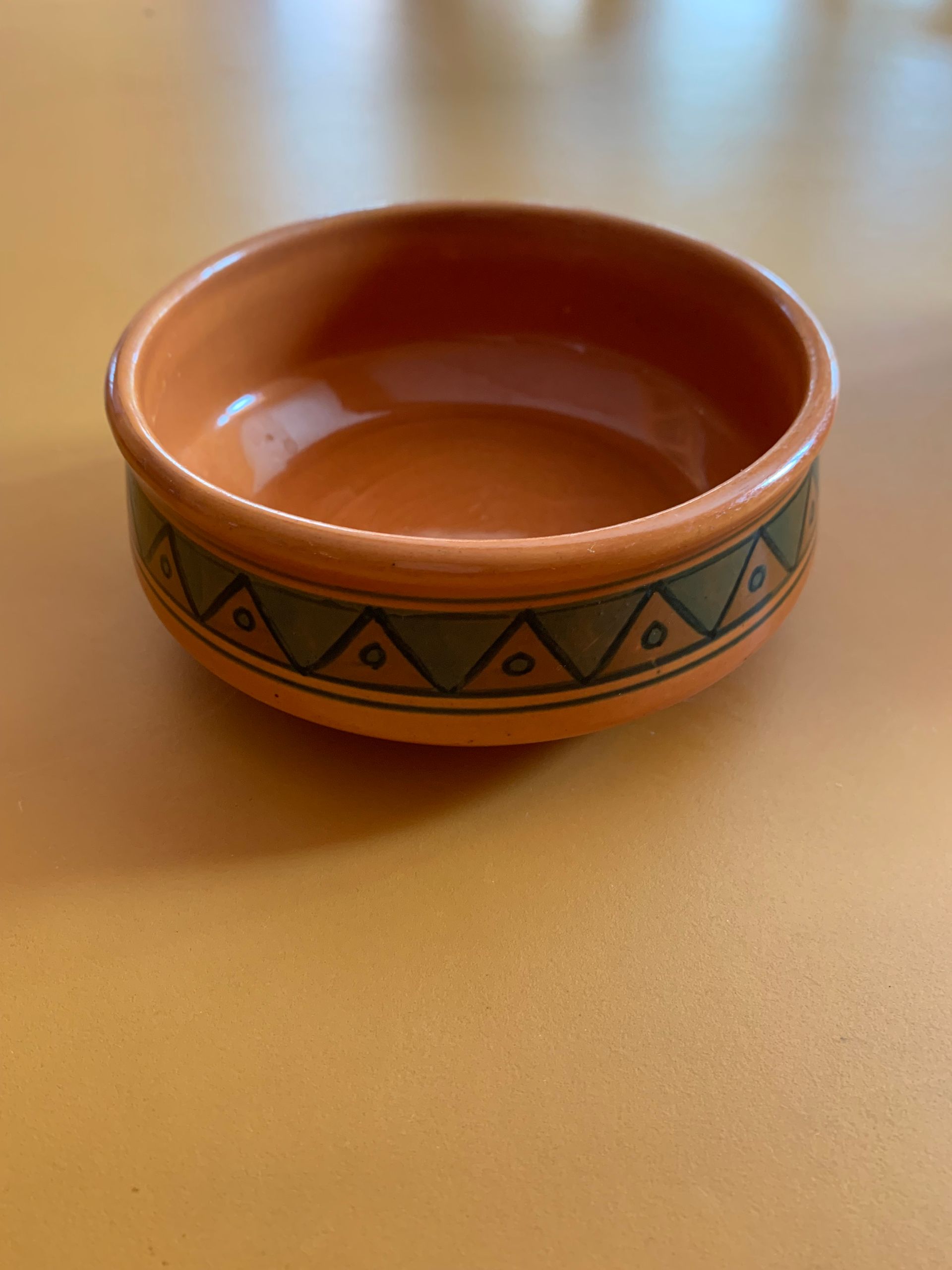 A small bowl is sitting on a table