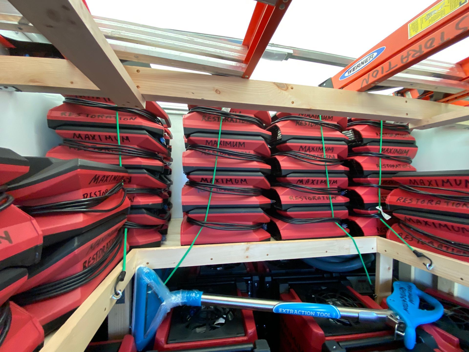 Stacks of red and black exercise equipment inside a storage area.