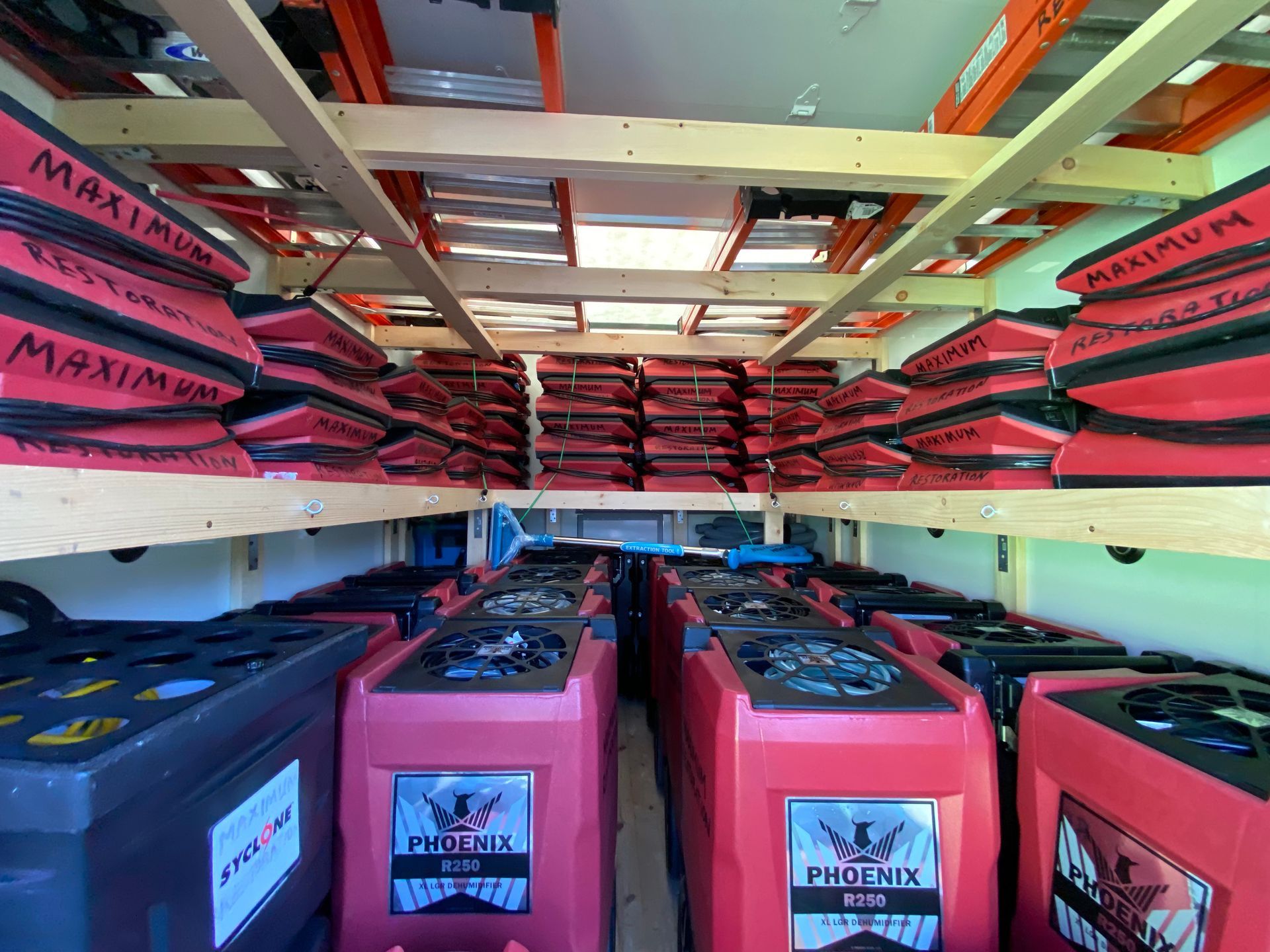 Inside a trailer filled with red and black restoration equipment.