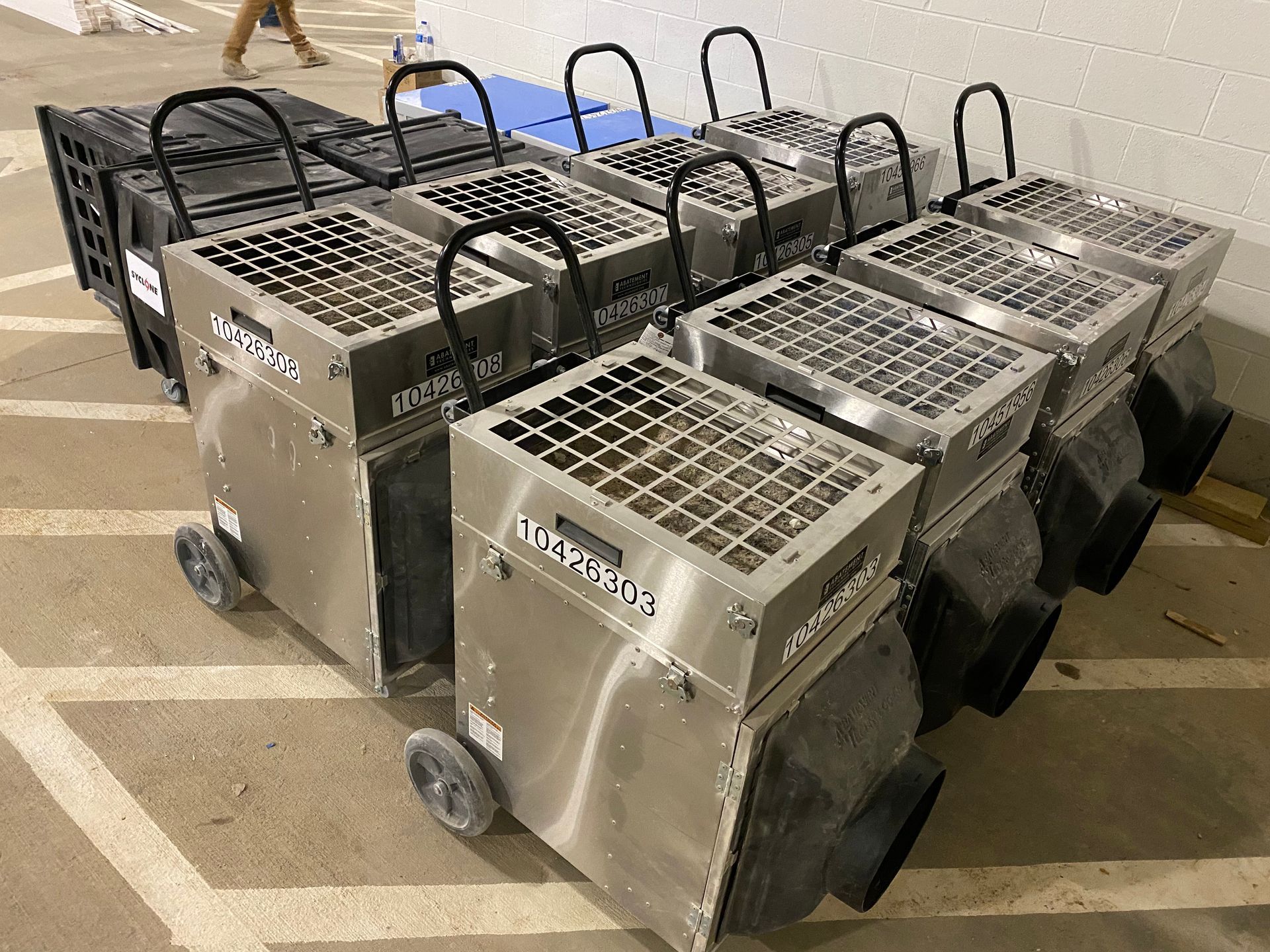 Row of silver dehumidifiers on wheels.