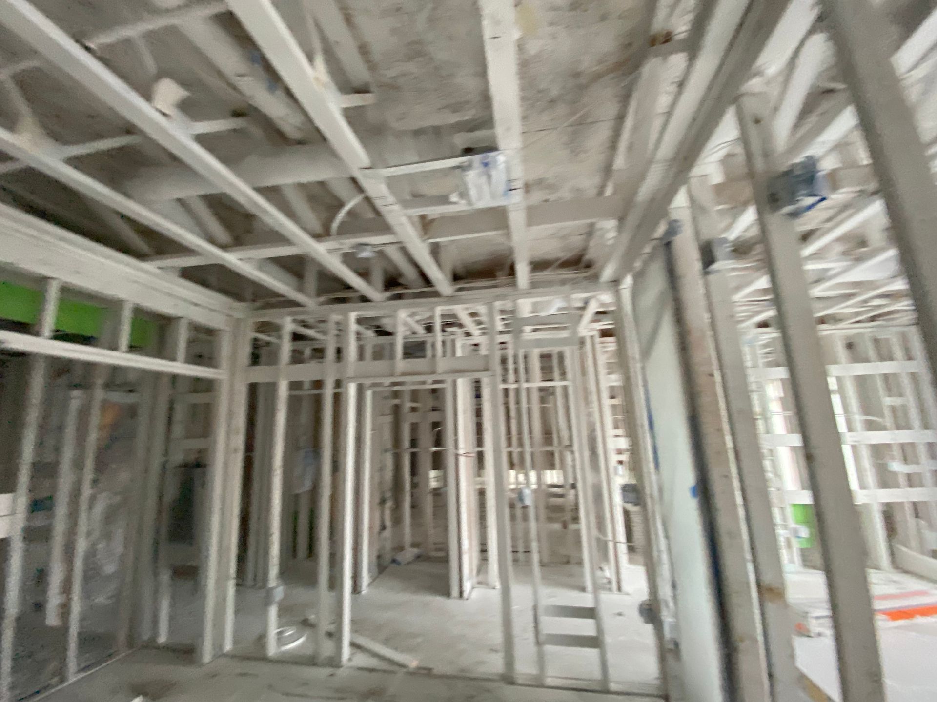 Interior of a building under construction, wooden frames of walls and ceiling visible.