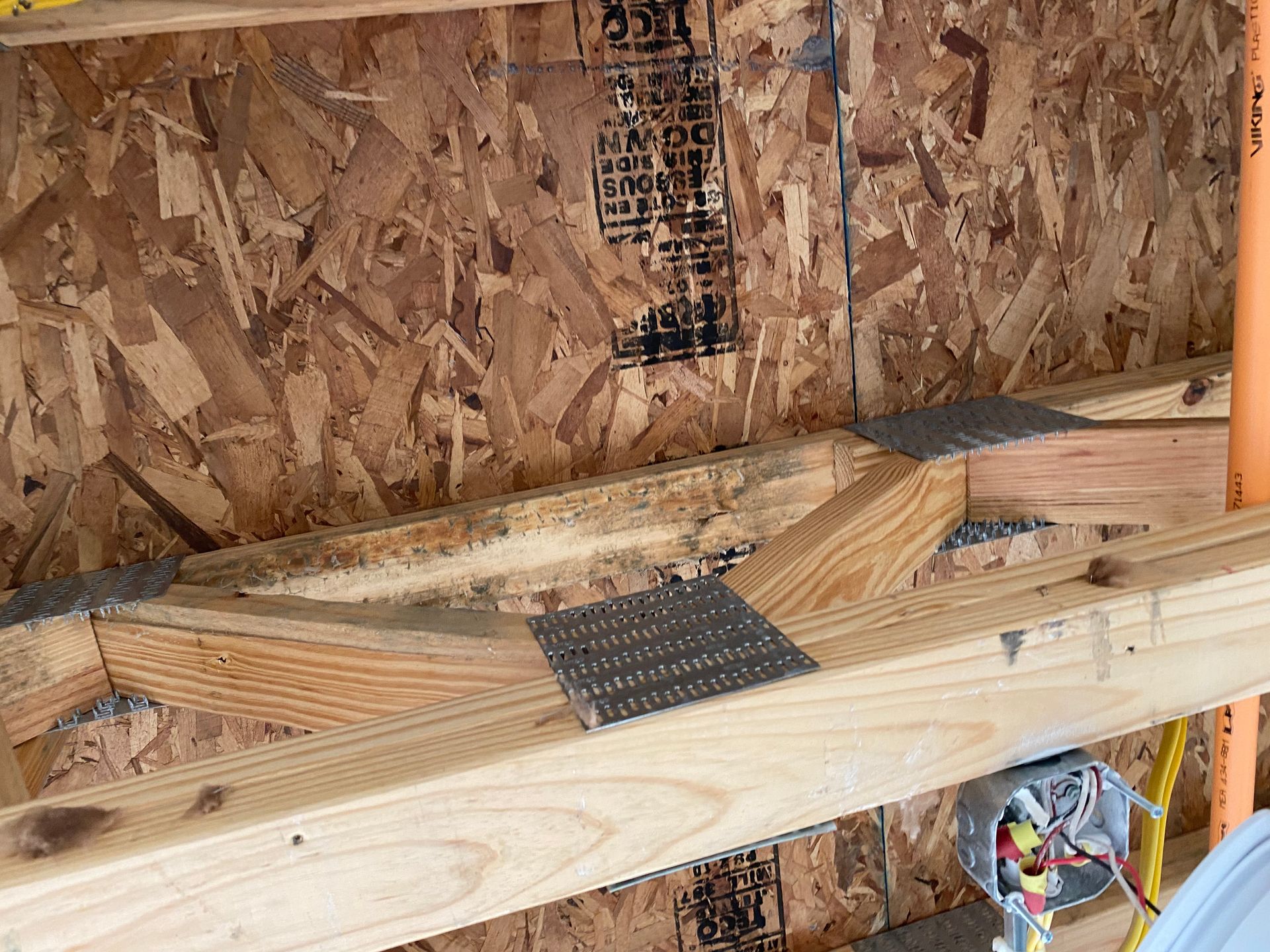 Wooden roof truss construction with metal connector plates.