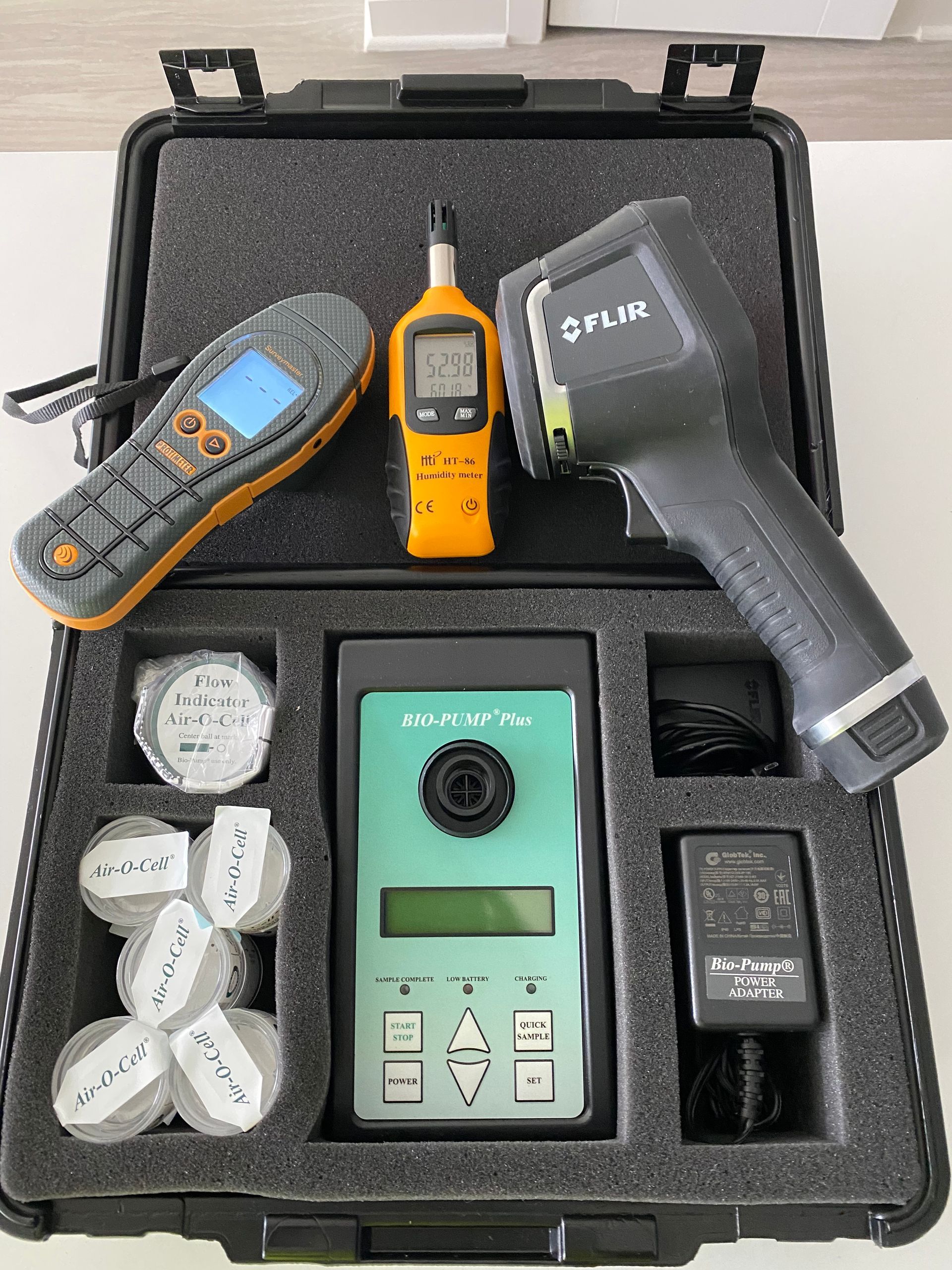 A case with environmental testing equipment: meters, thermal camera, and sensors.