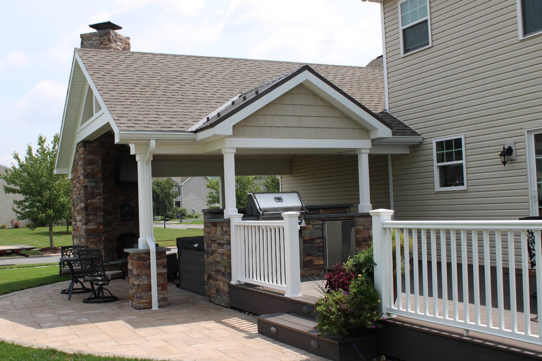 A house with a porch and a grill on it