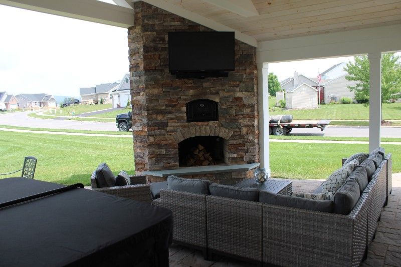 A living room with a fireplace and a flat screen tv.