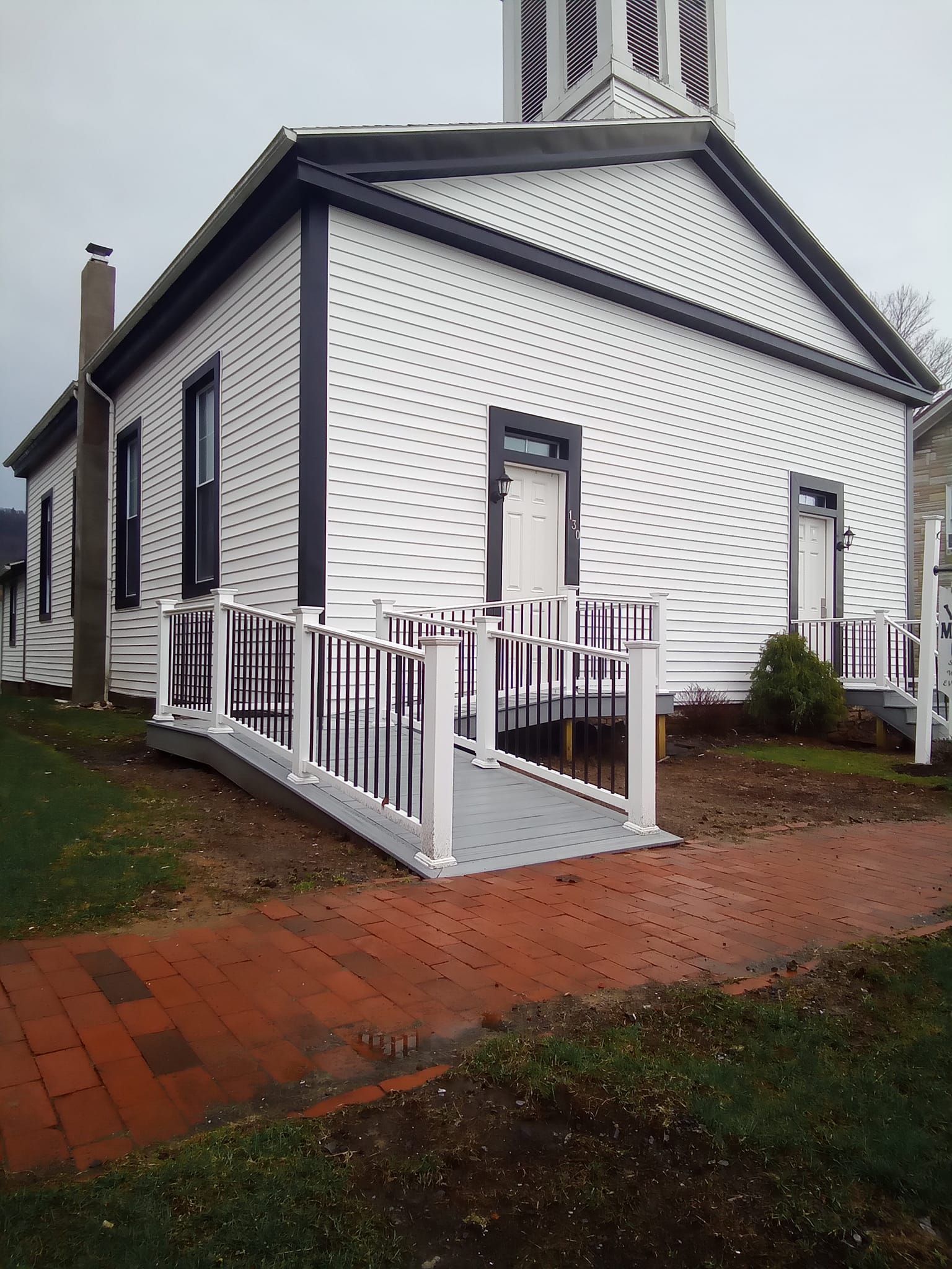 A white building with a ramp leading to it
