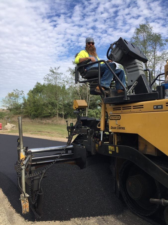 man on asphalt paver