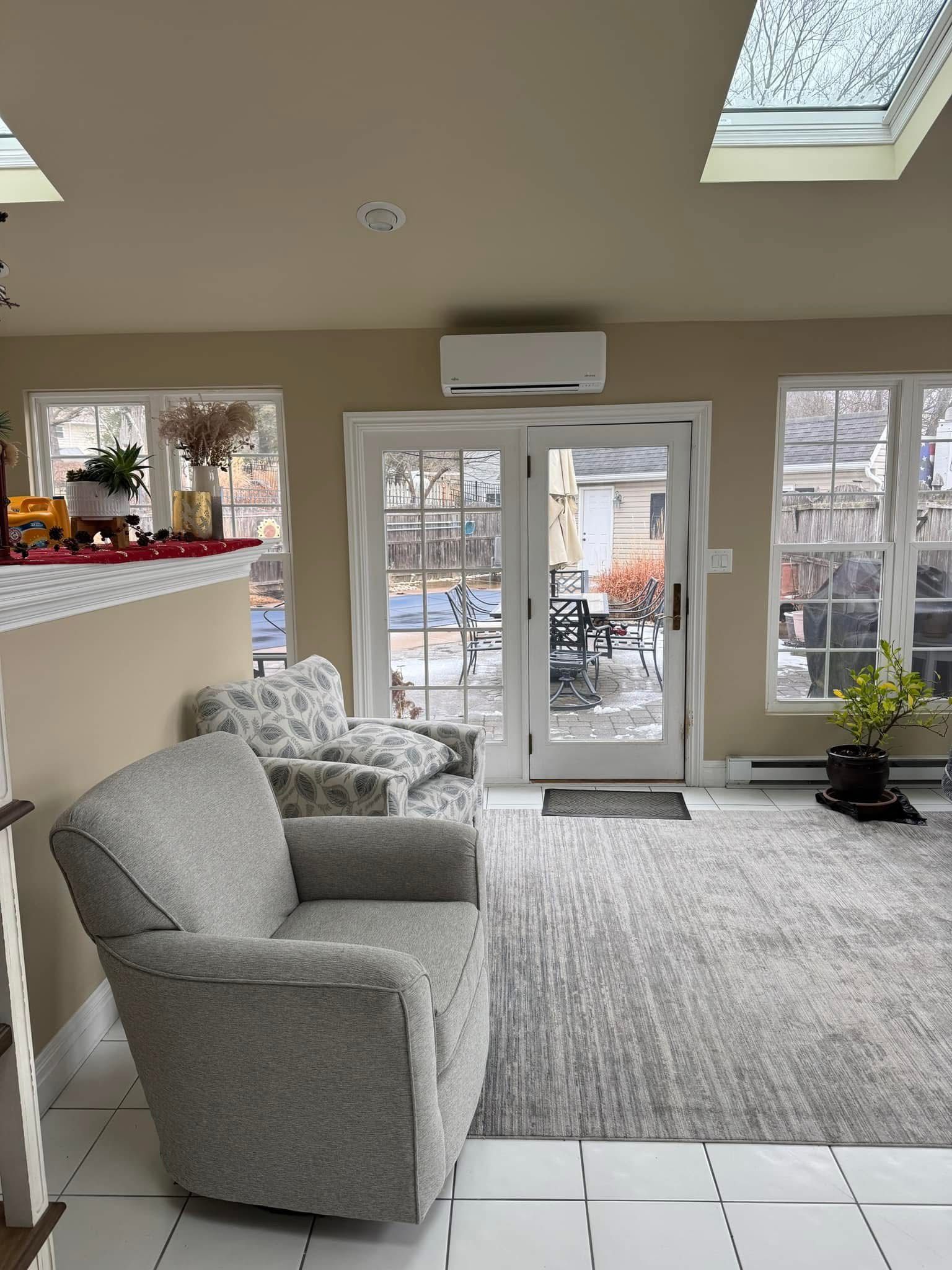 A living room with a couch, chair, and skylight.