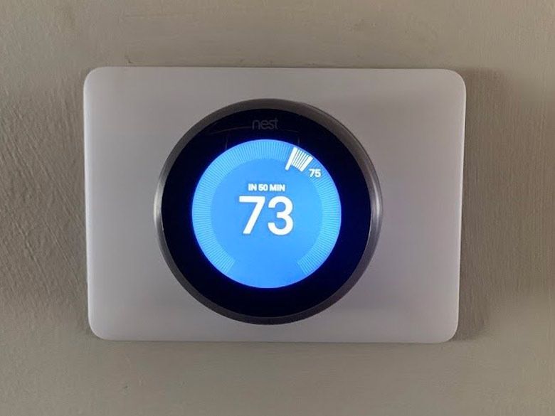 A smart thermostat is displaying a temperature.