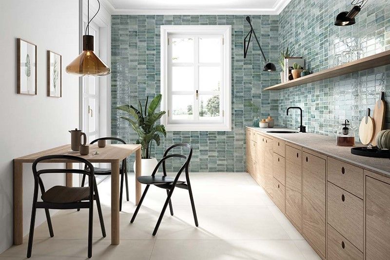 A kitchen with a table and chairs and a window.