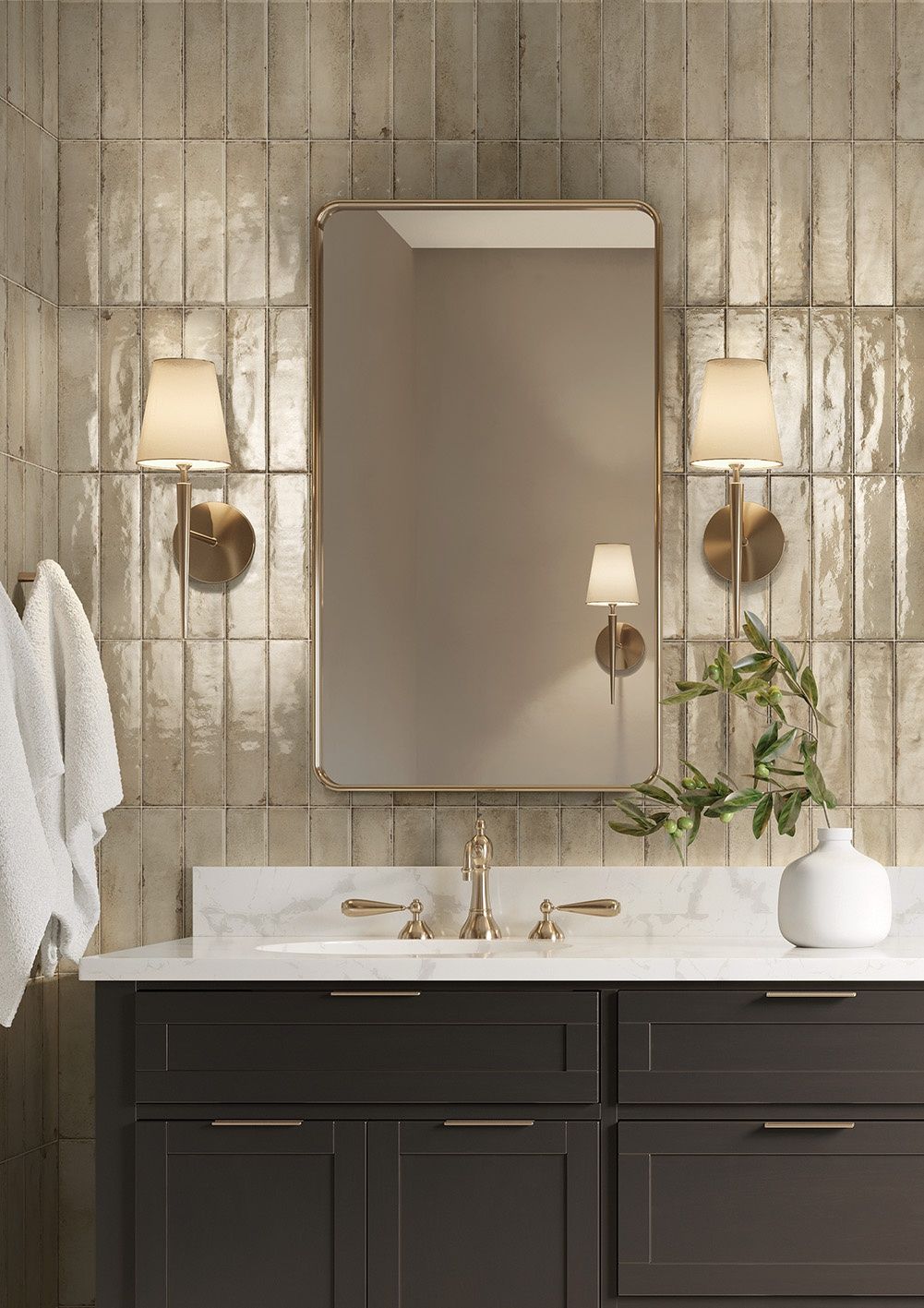 A bathroom with a sink , mirror and lamps.