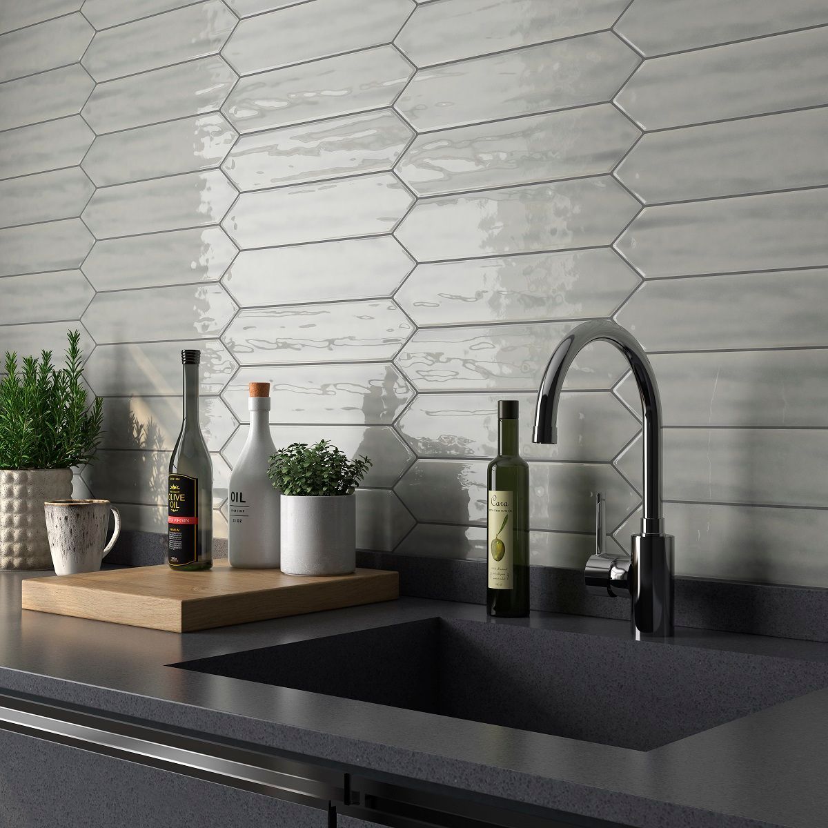 A kitchen counter with a sink and bottles on it