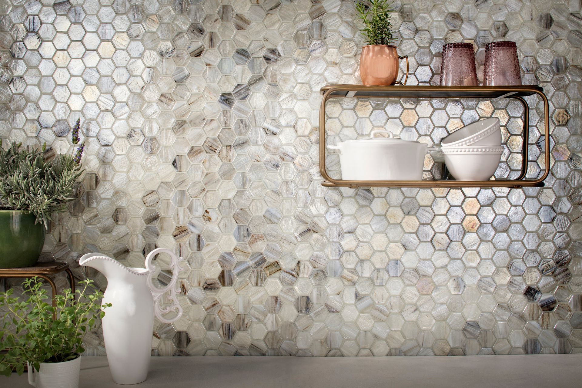 A kitchen with a hexagonal tile wall and a shelf with pots and pans on it.