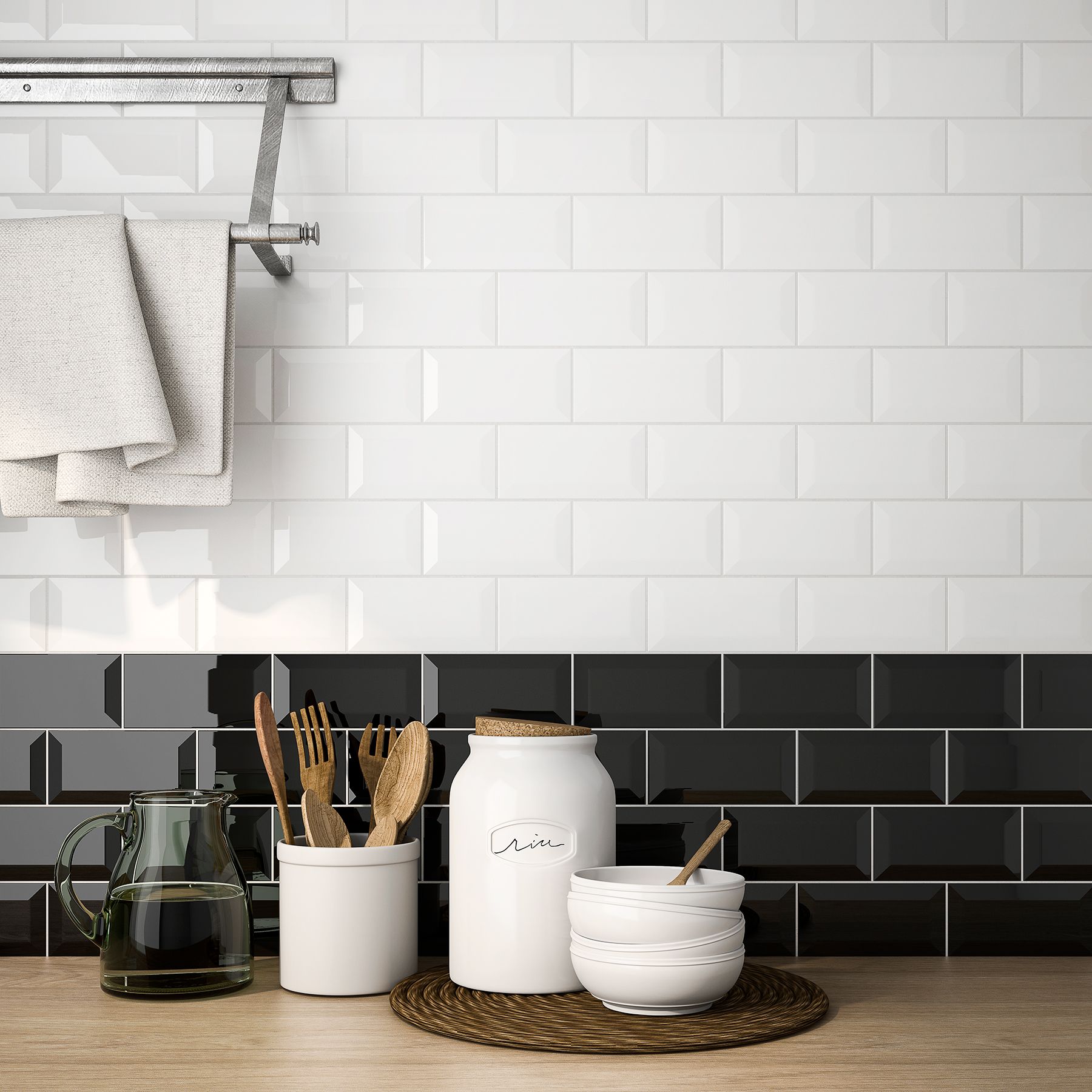 A kitchen counter with black and white tiles and utensils on it.
