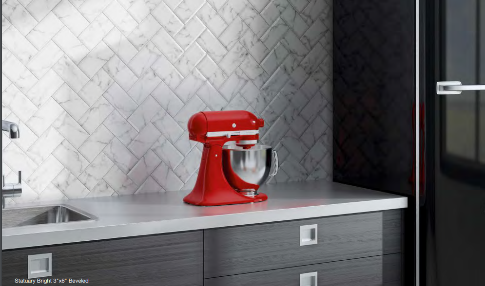 A red kitchenaid mixer is sitting on a counter in a kitchen.