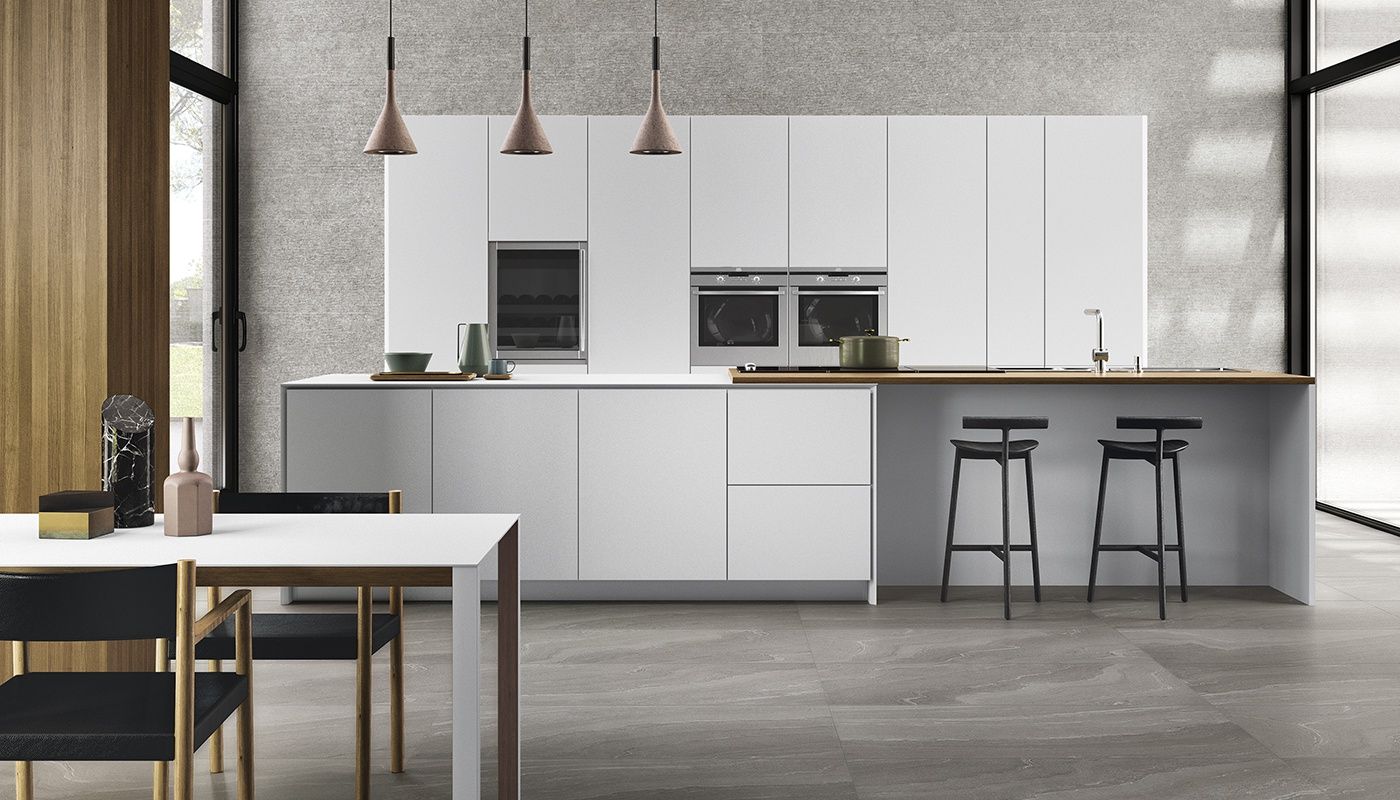 A kitchen with white cabinets and a table and chairs