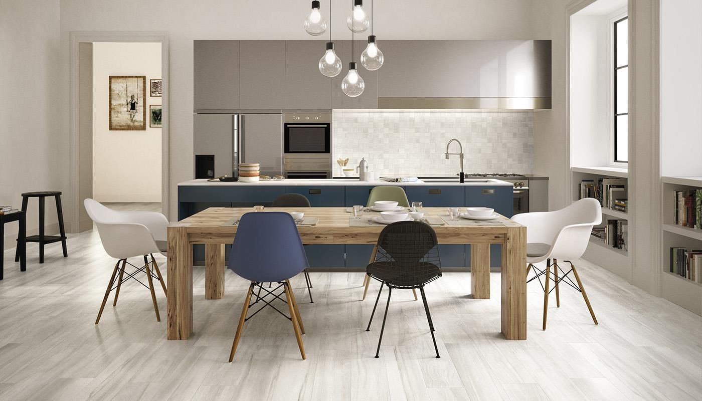 A kitchen with a table and chairs in it