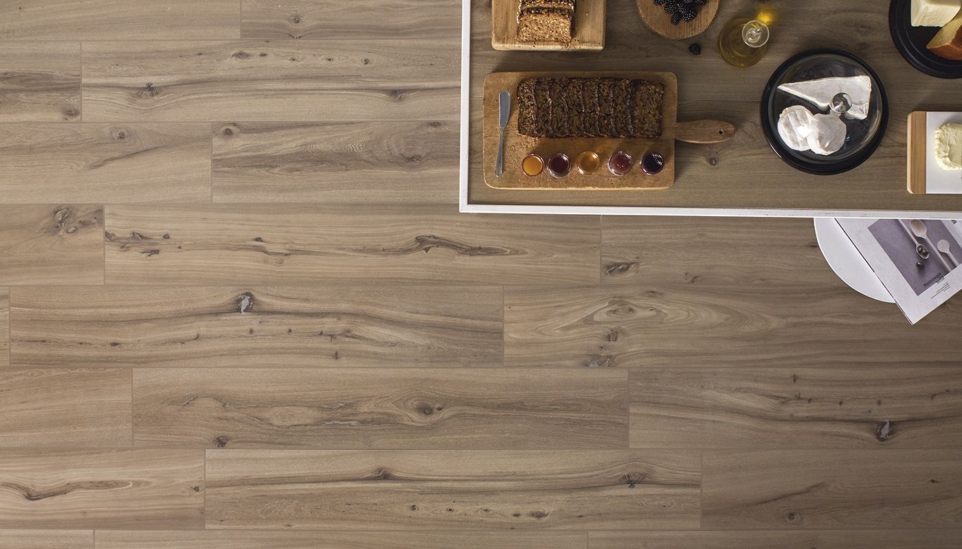 A wooden floor with a table and plates of food on it.