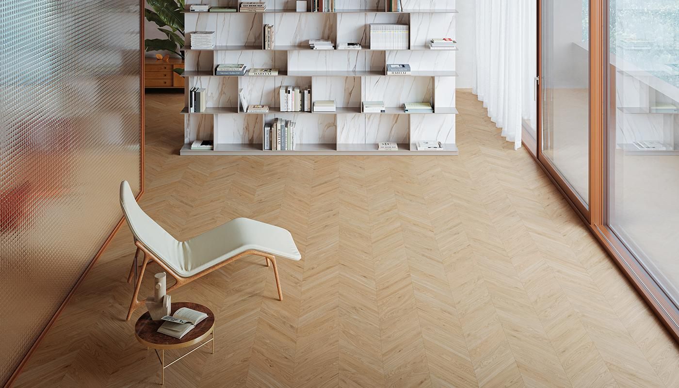 A chair is sitting in a living room next to a bookshelf.